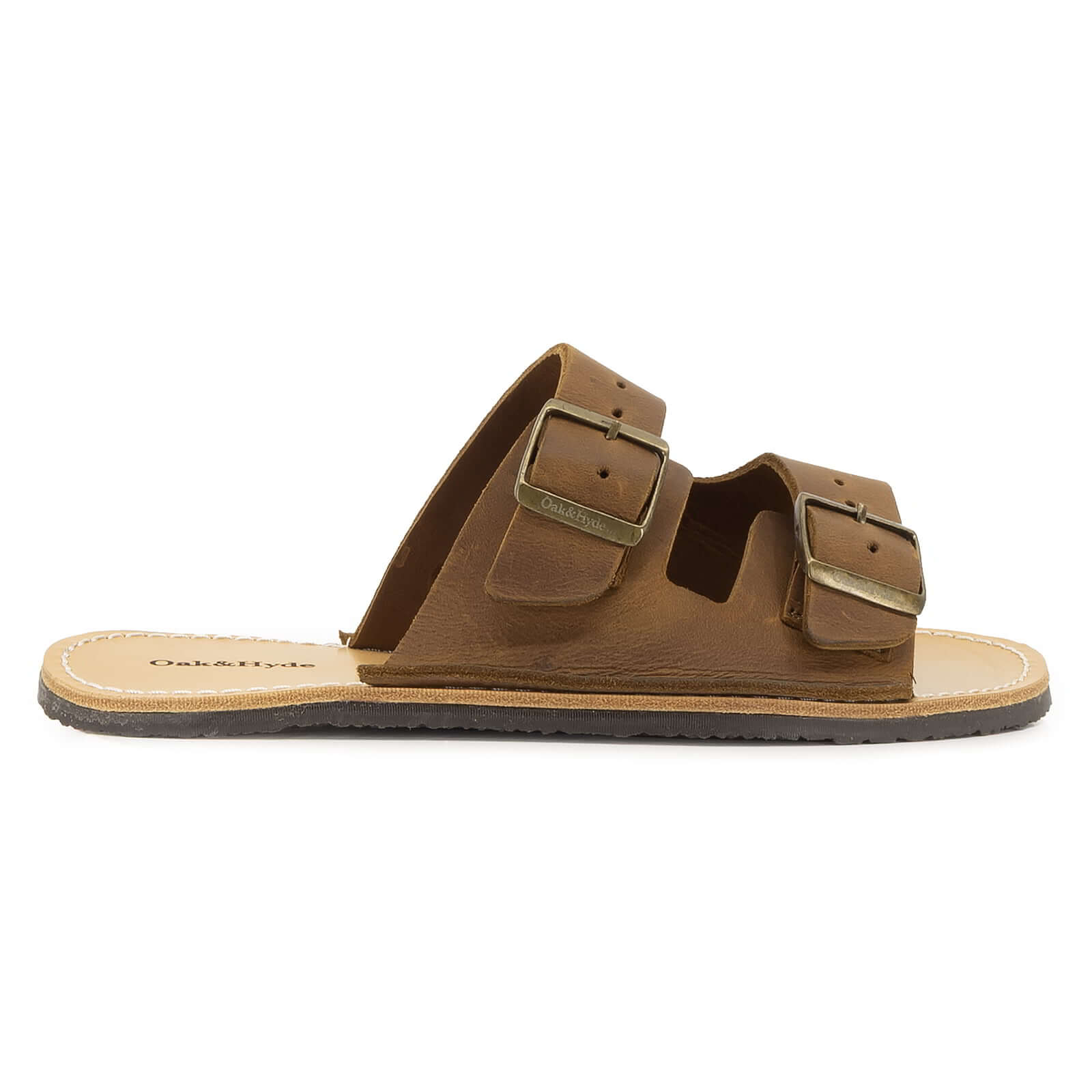 side profile view of acacia barefoot sandals in brown showing upper design and buckles