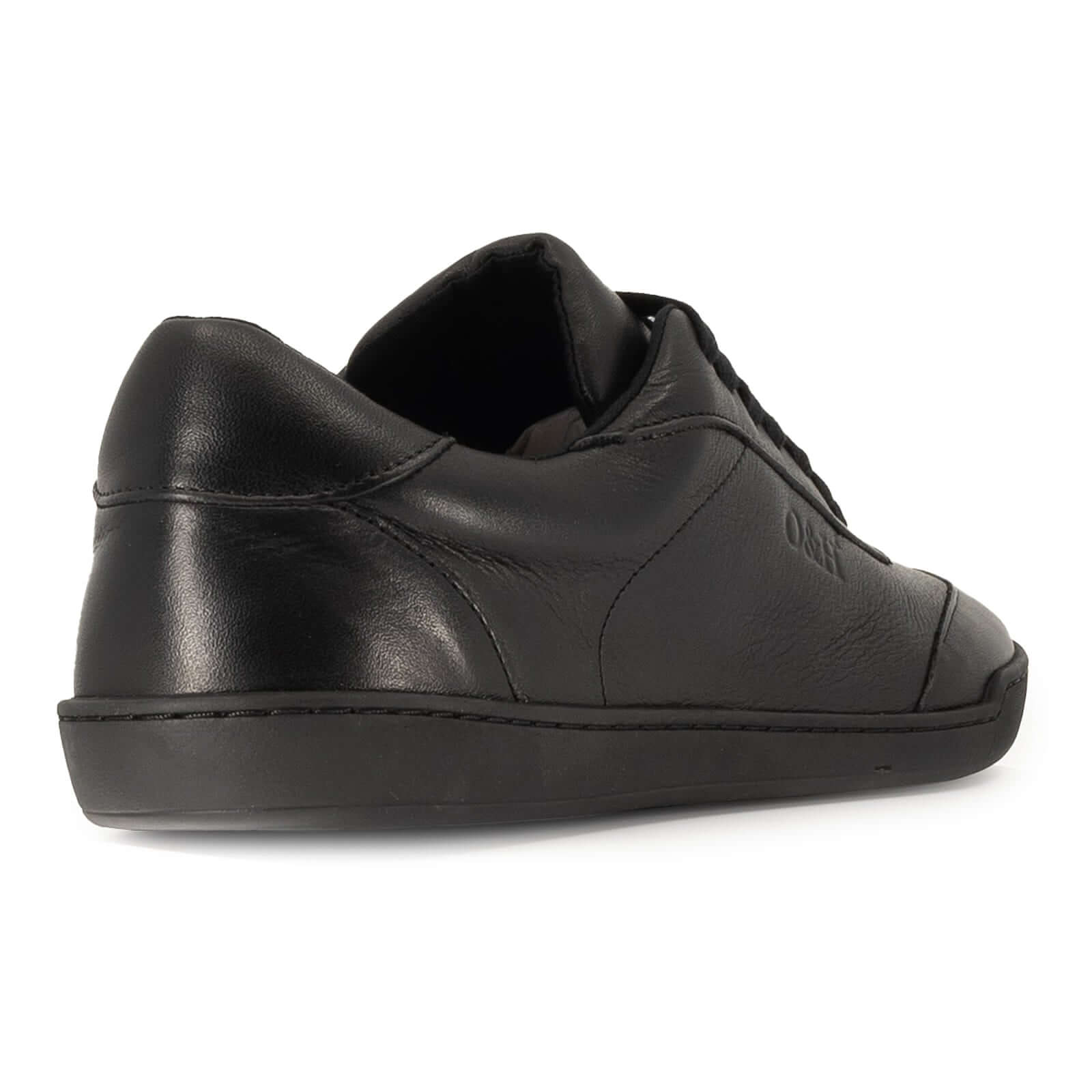 heel view of aspen black barefoot trainers showing leather panels on white background