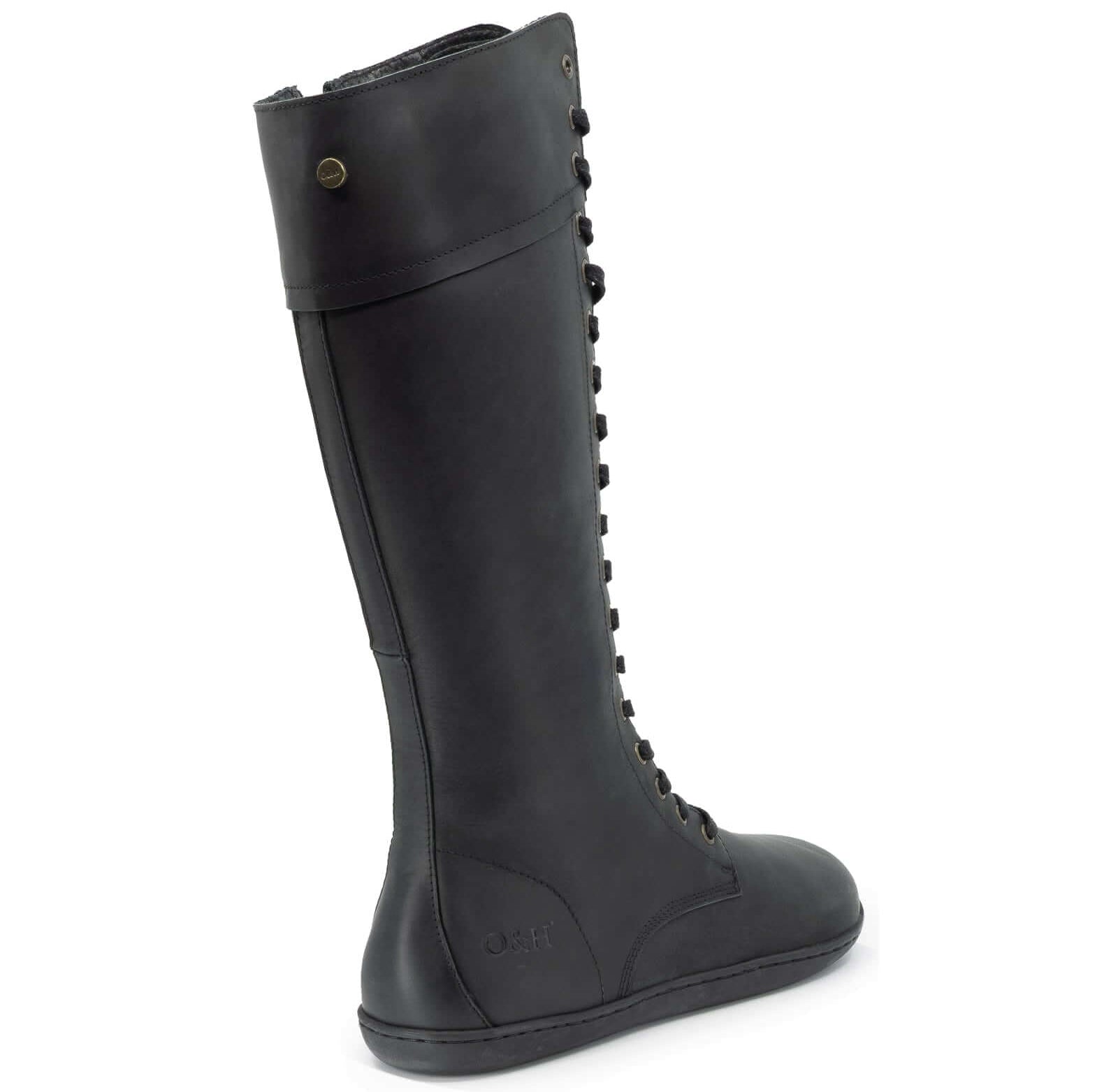 rear view of tall black barefoot boots showing leather upper on white background