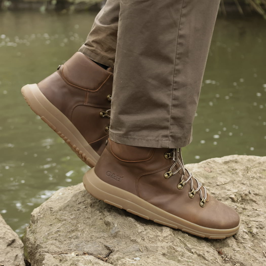 model standing on rock in blackthorn barefoot walking boots in brown