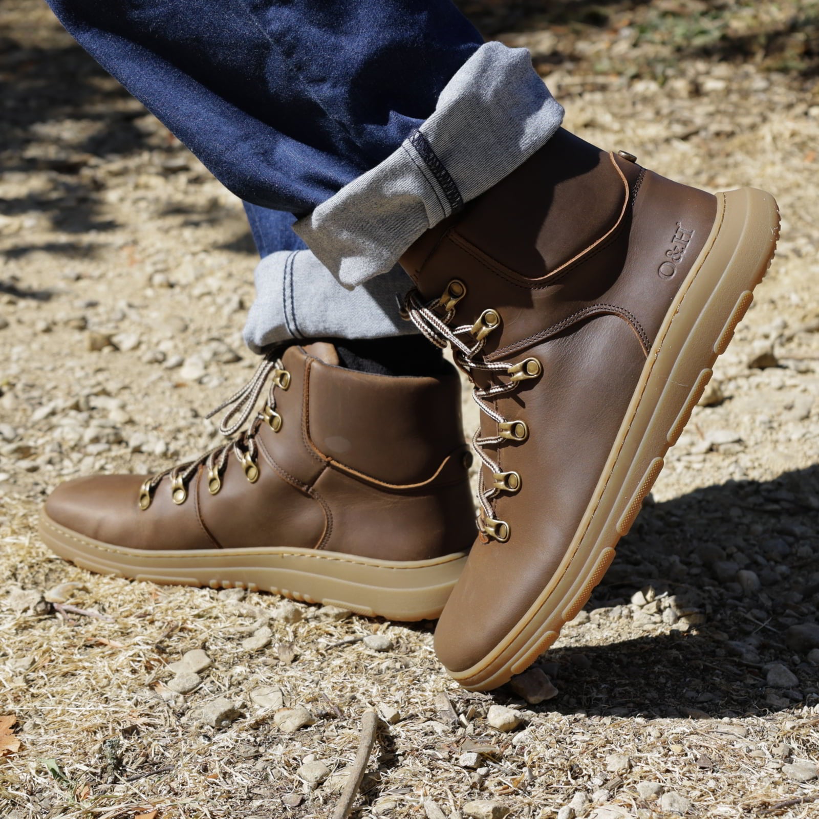 model wearing blackthorn barefoot walking boots in brown on stone path outdoors