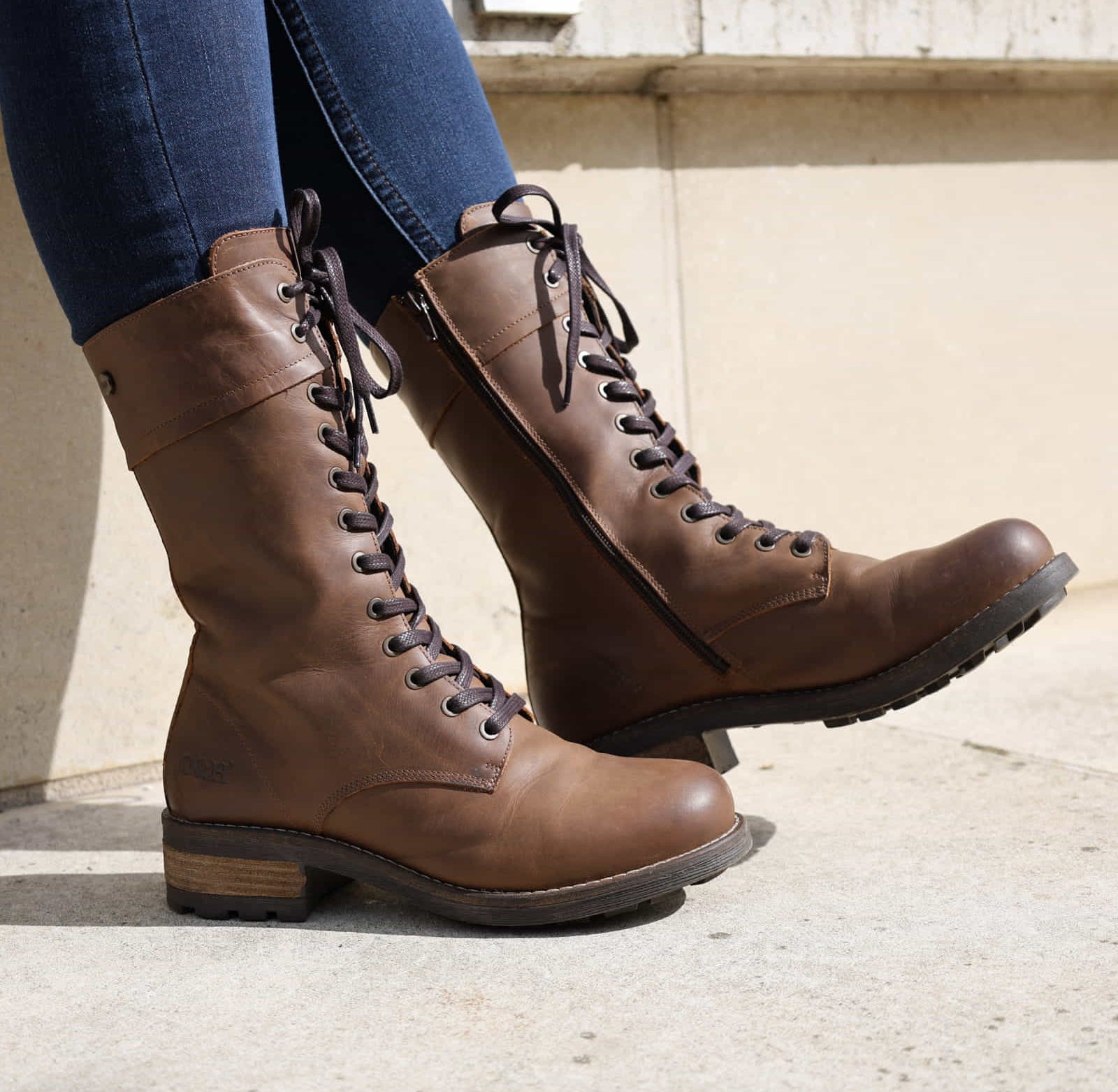 Dark brown Bridge 12 military boots worn with jeans, front angled view outdoors