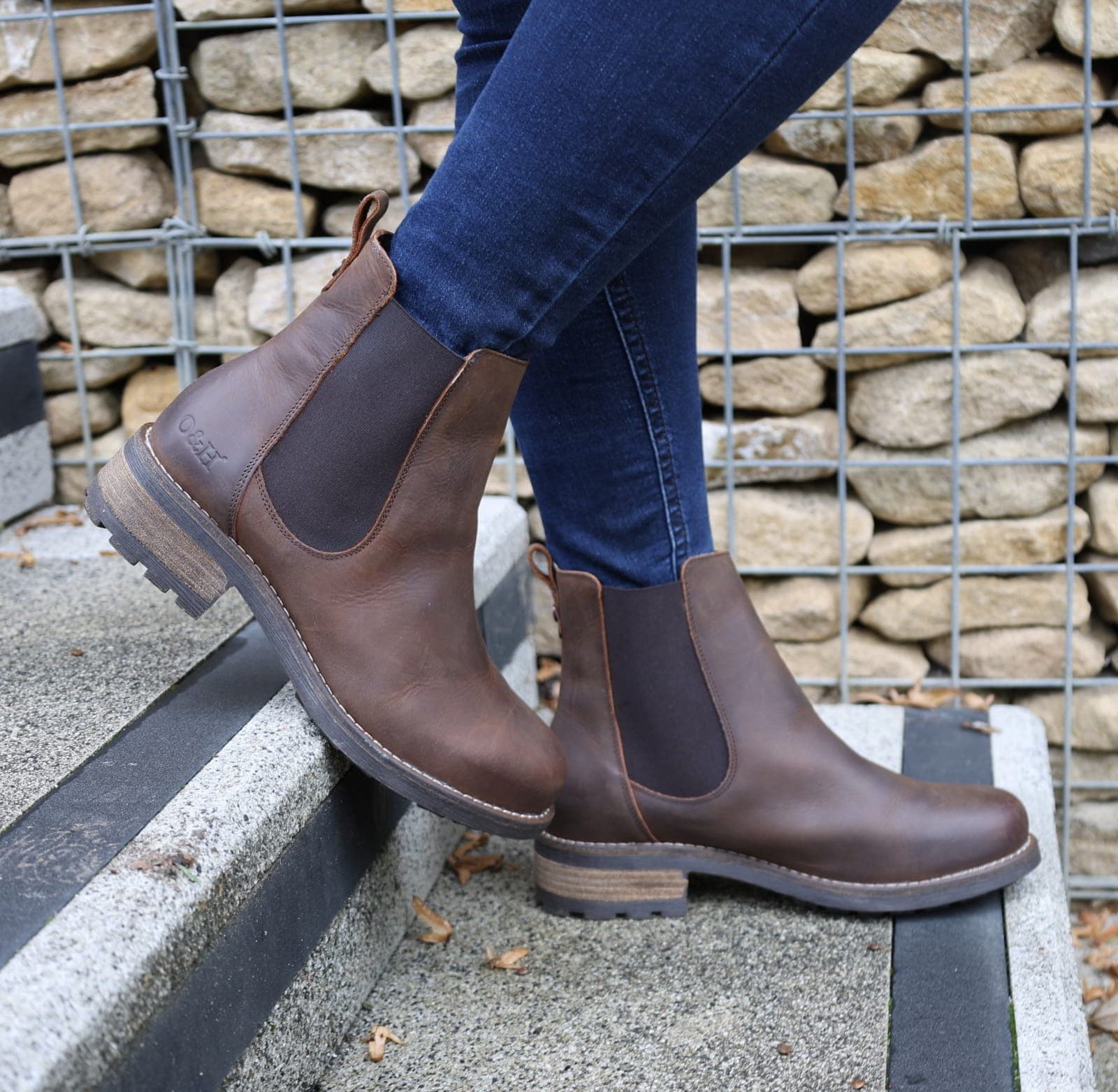 Dark brown Bridge Chelsea 2 boots worn with jeans outdoors on a paved surface