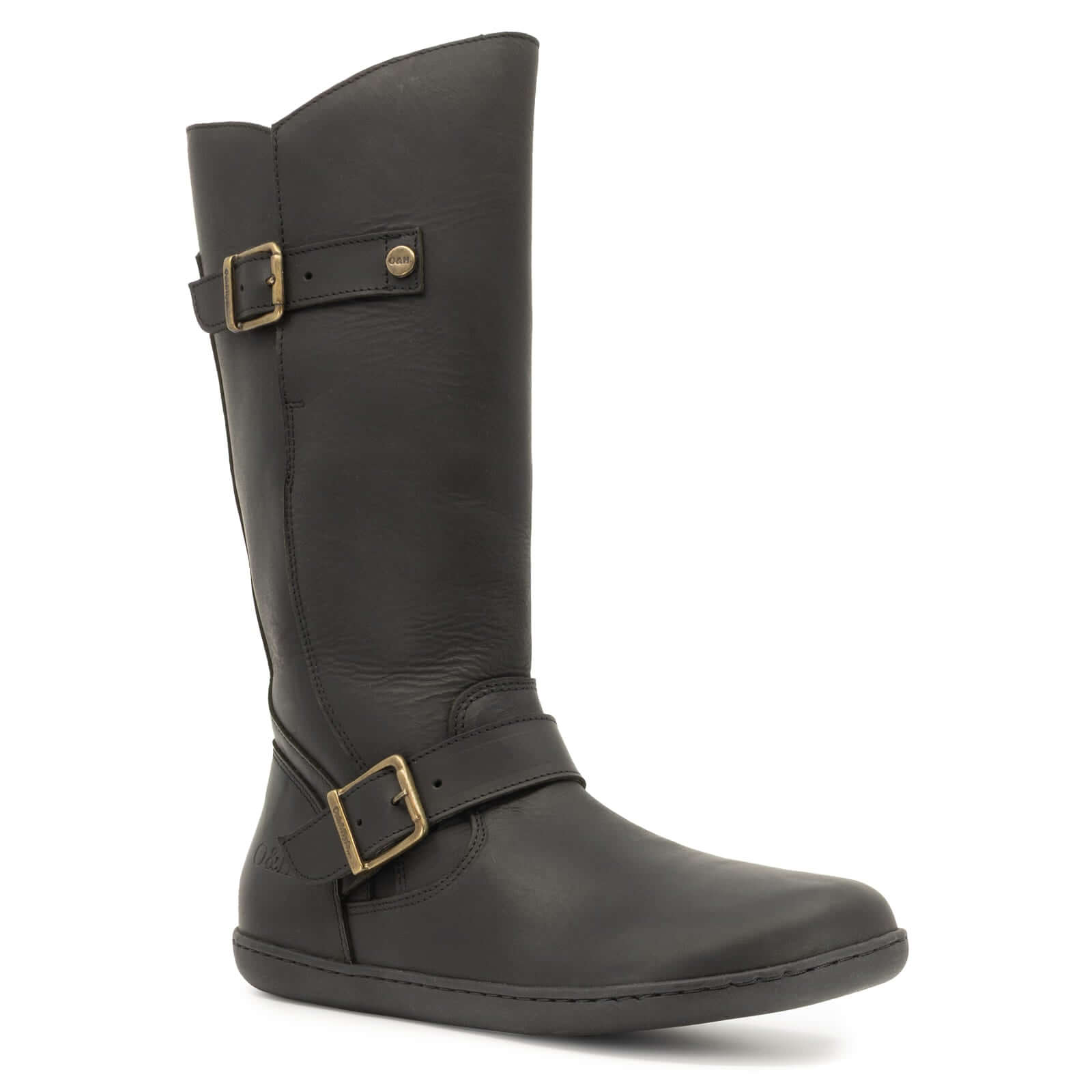 angled outside view of black cedar barefoot boots showing leather upper and buckles