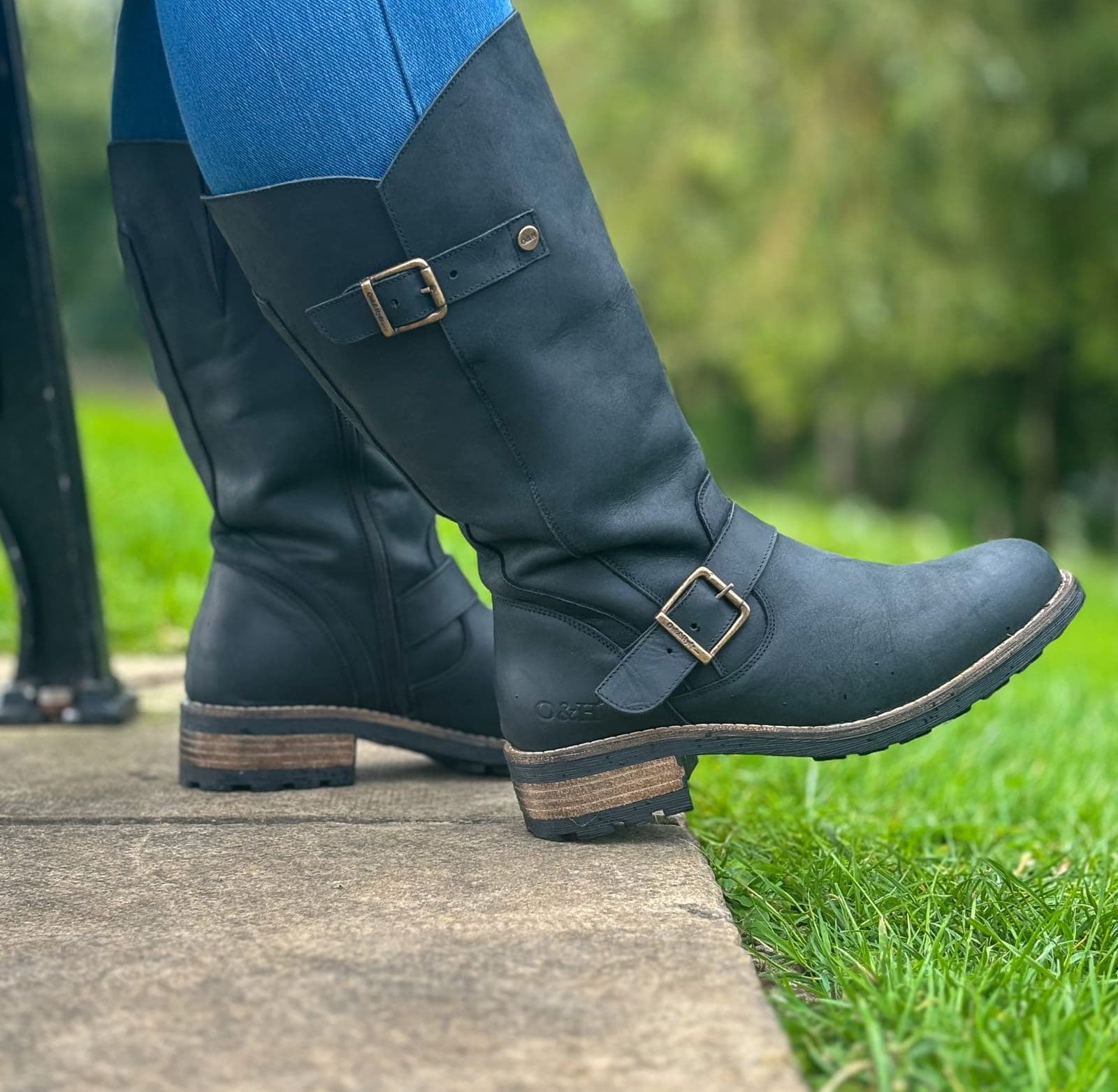 Black Crest 2 wide calf tall boots worn outdoors stepping forward