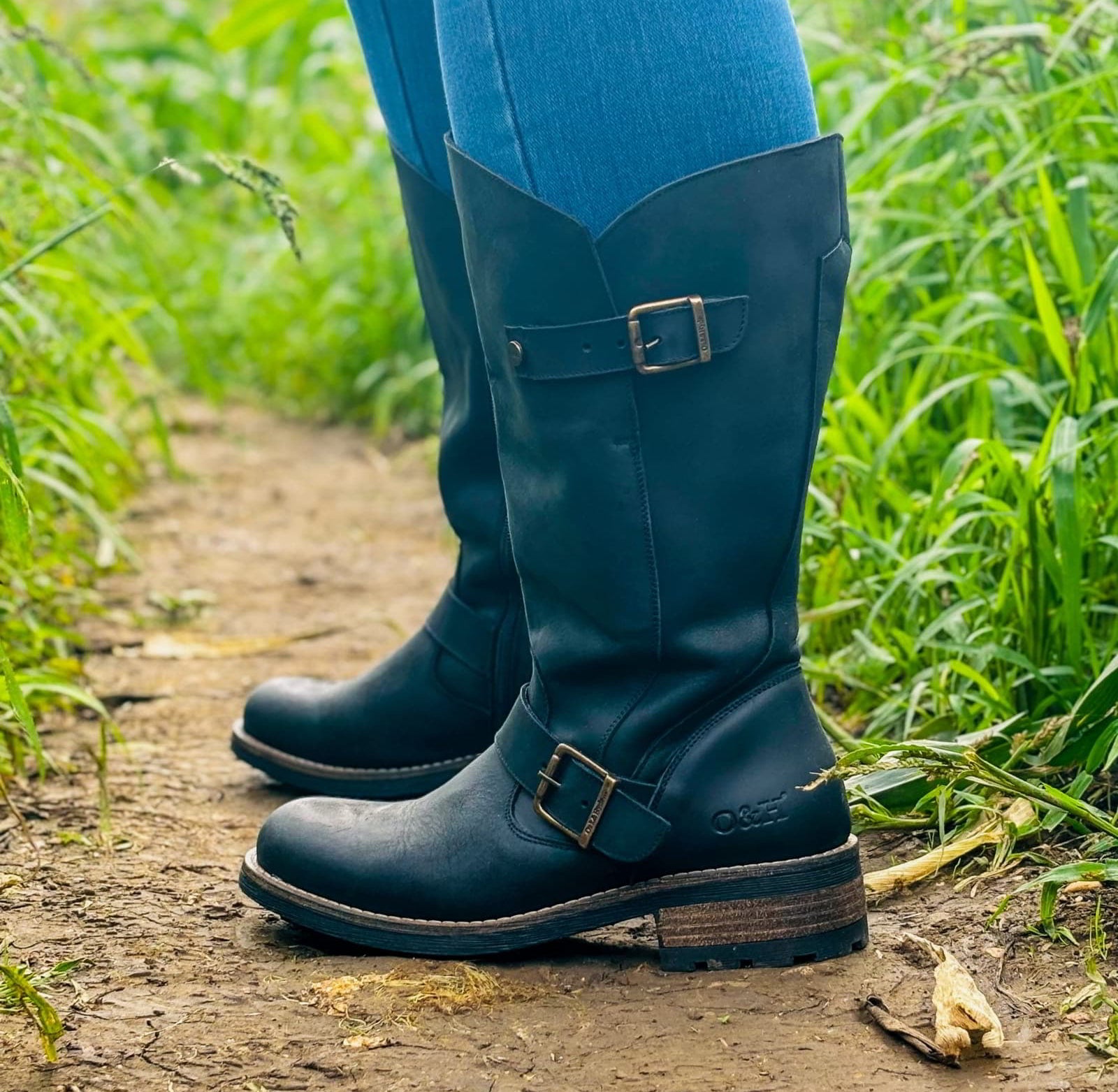 Black Crest 2 wide calf tall boots worn outdoors while walking on grass