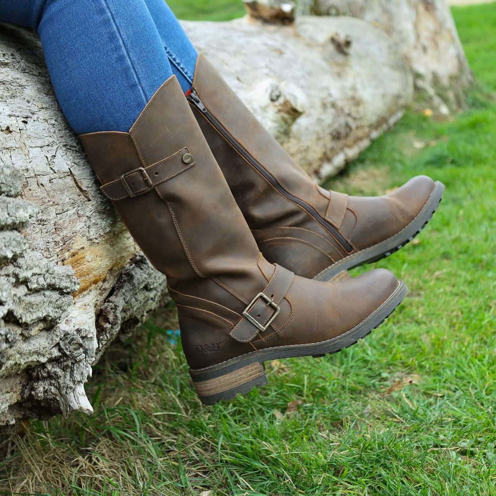 Dark brown Crest 2 tall boots worn outdoors with feet resting on stone