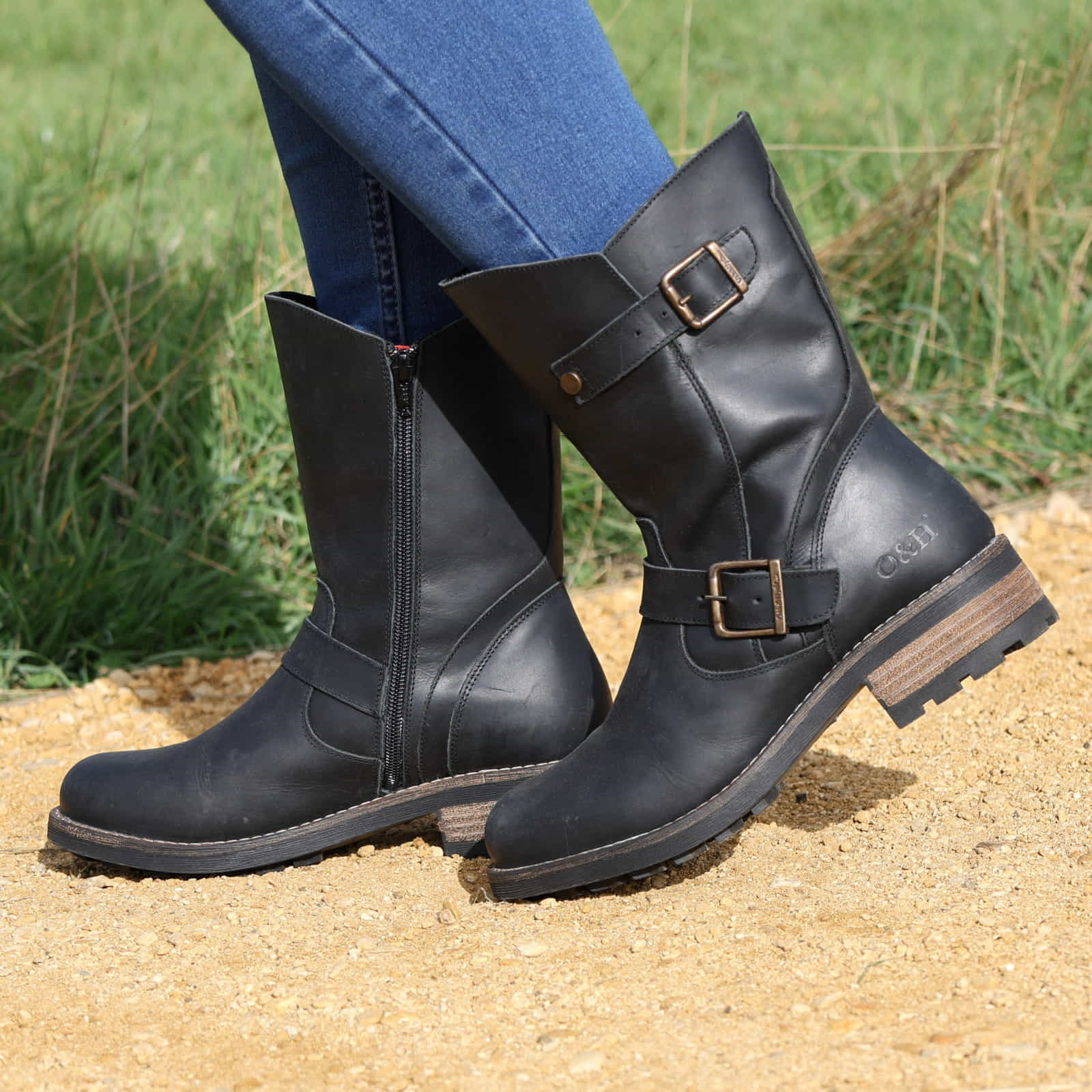 Black Crest Demi 2 ankle boots worn outdoors stepping on sandy ground