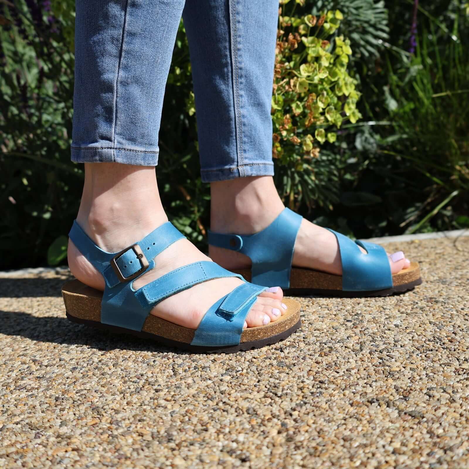 turquoise oak & hyde daisy sandals worn outdoors showing open toe straps and cork footbed
