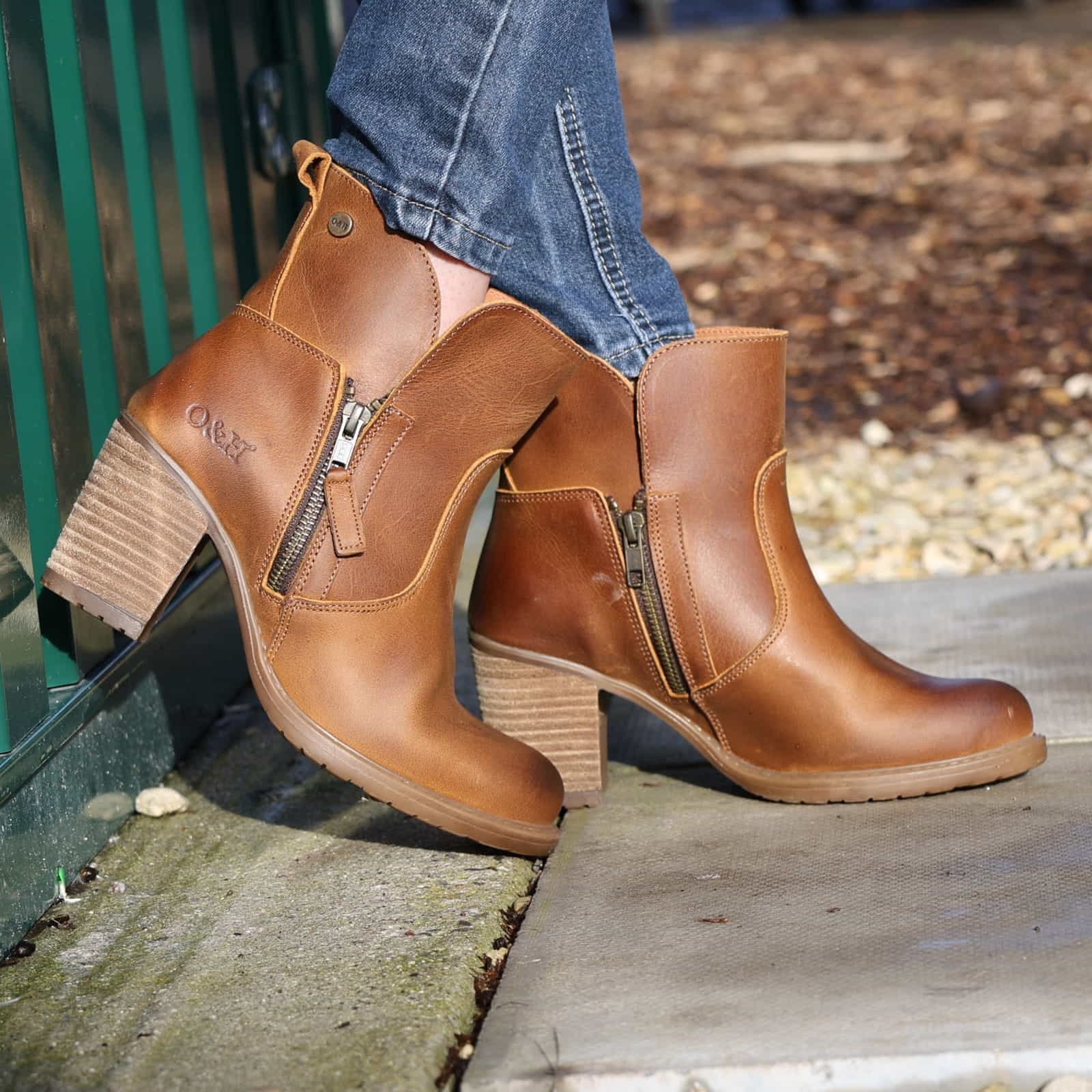 model leaning against metal container wearing Eastside 2 western boots with jeans