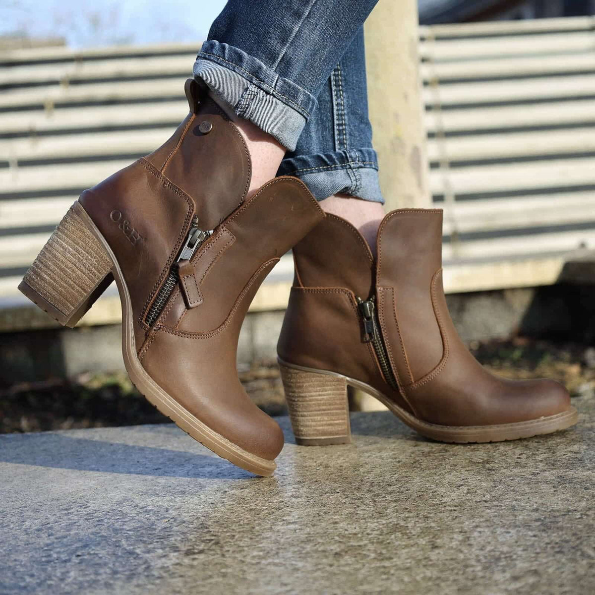 model standing on concrete wearing Eastside 2 women's leather ankle boots with light blue jeans