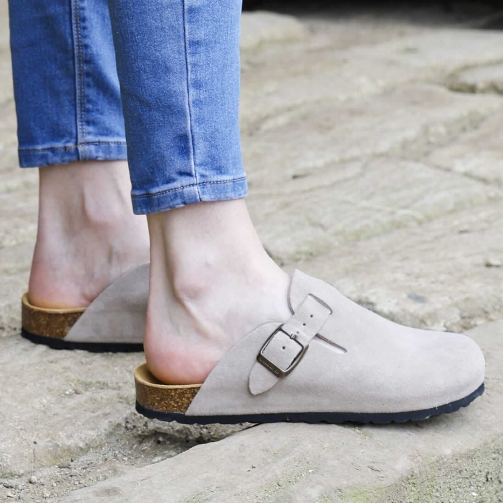 model standing on stone path wearing gibraltar 2 leather clogs with jeans