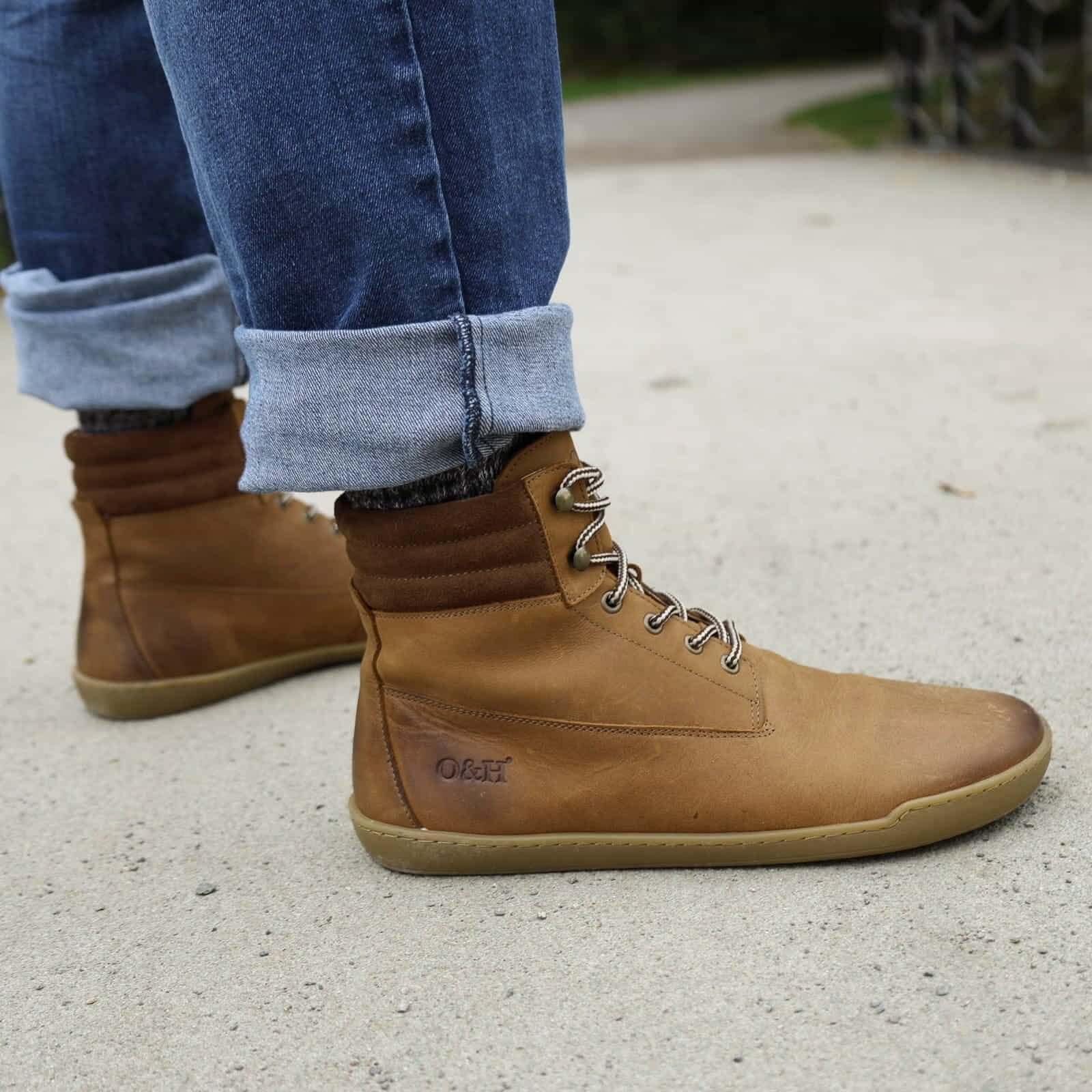 model wearing hawthorn barefoot boots with blue jeans on a pebbled path
