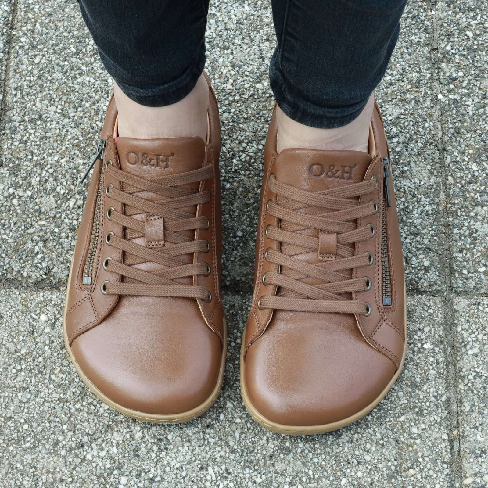 model wearing hazel zip barefoot trainers in tan showing view of toe box