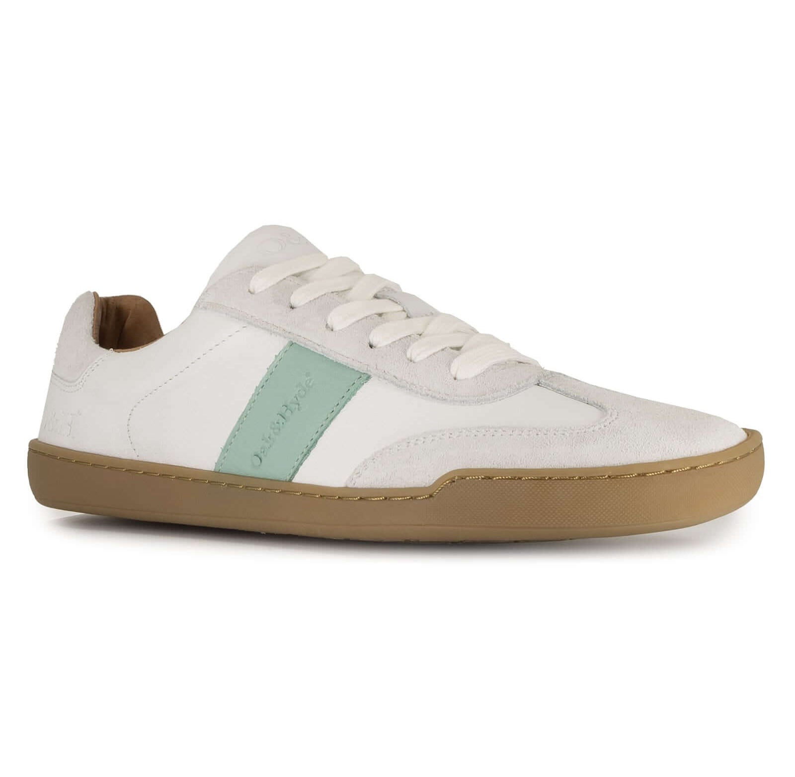 White barefoot trainer with gum sole and green accent on a white background