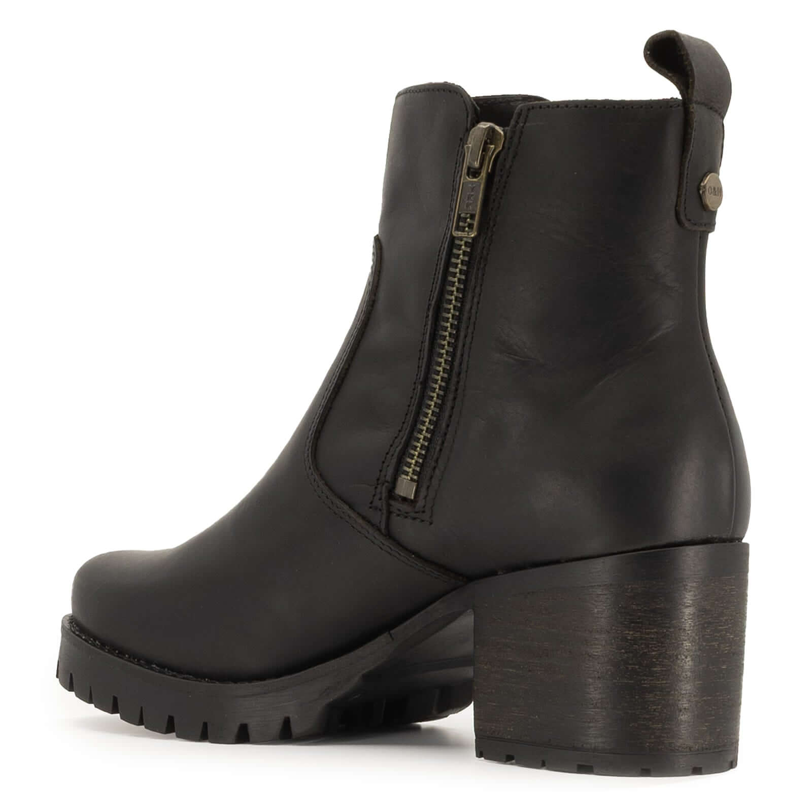 inside angle view of black oak & hyde kensington zip ankle boots showing inner zip closure and heel