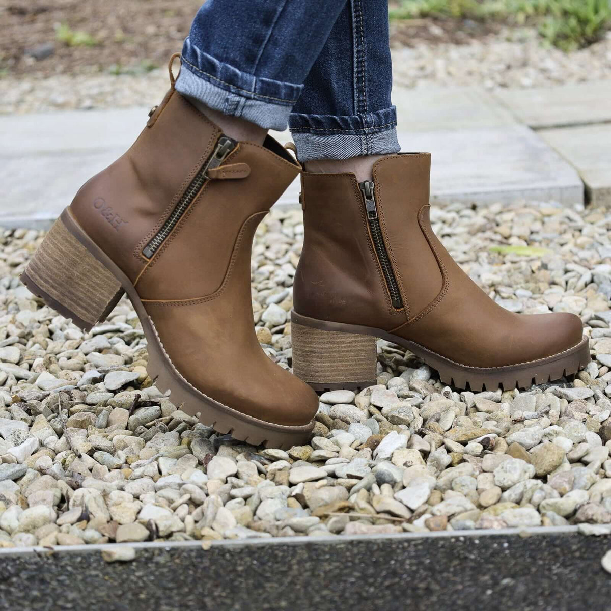 dark brown oak & hyde kensington zip ankle boots worn with jeans outdoors on gravel path