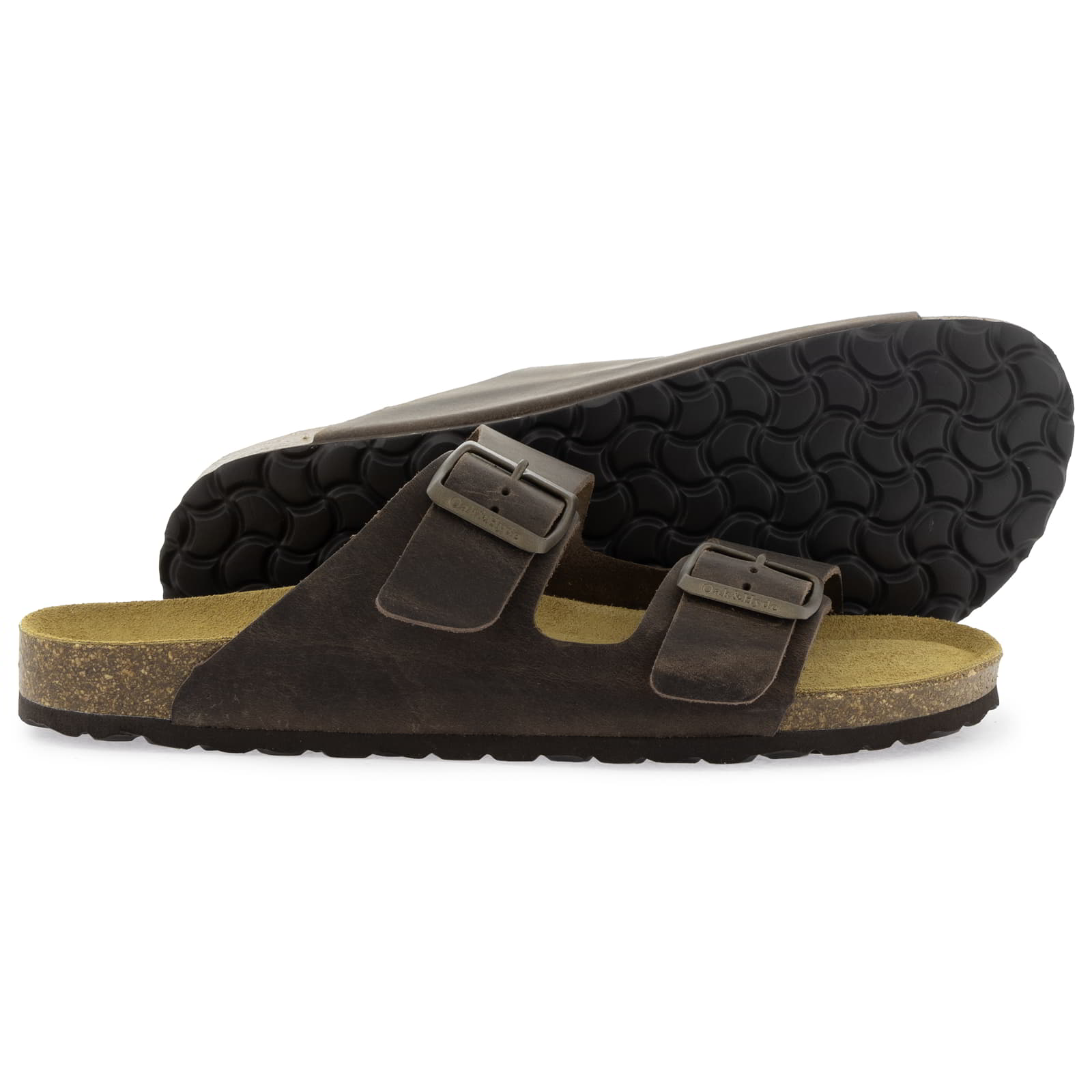 Dark brown leather fisherman sandals with two buckle straps, cork footbeds, and textured rubber outsole visible