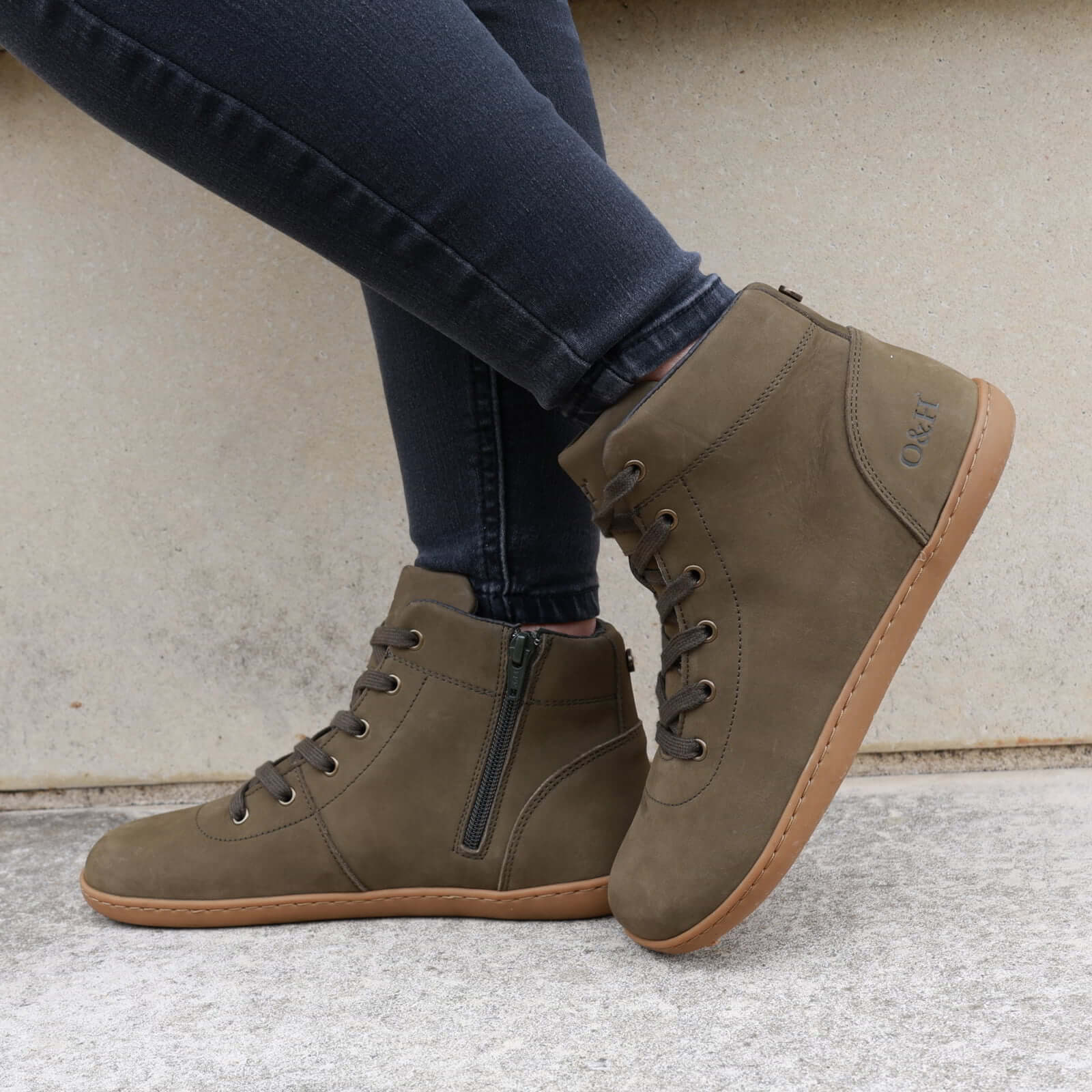 model wearing mulberry barefoot boots in khaki standing outdoors on a pavement