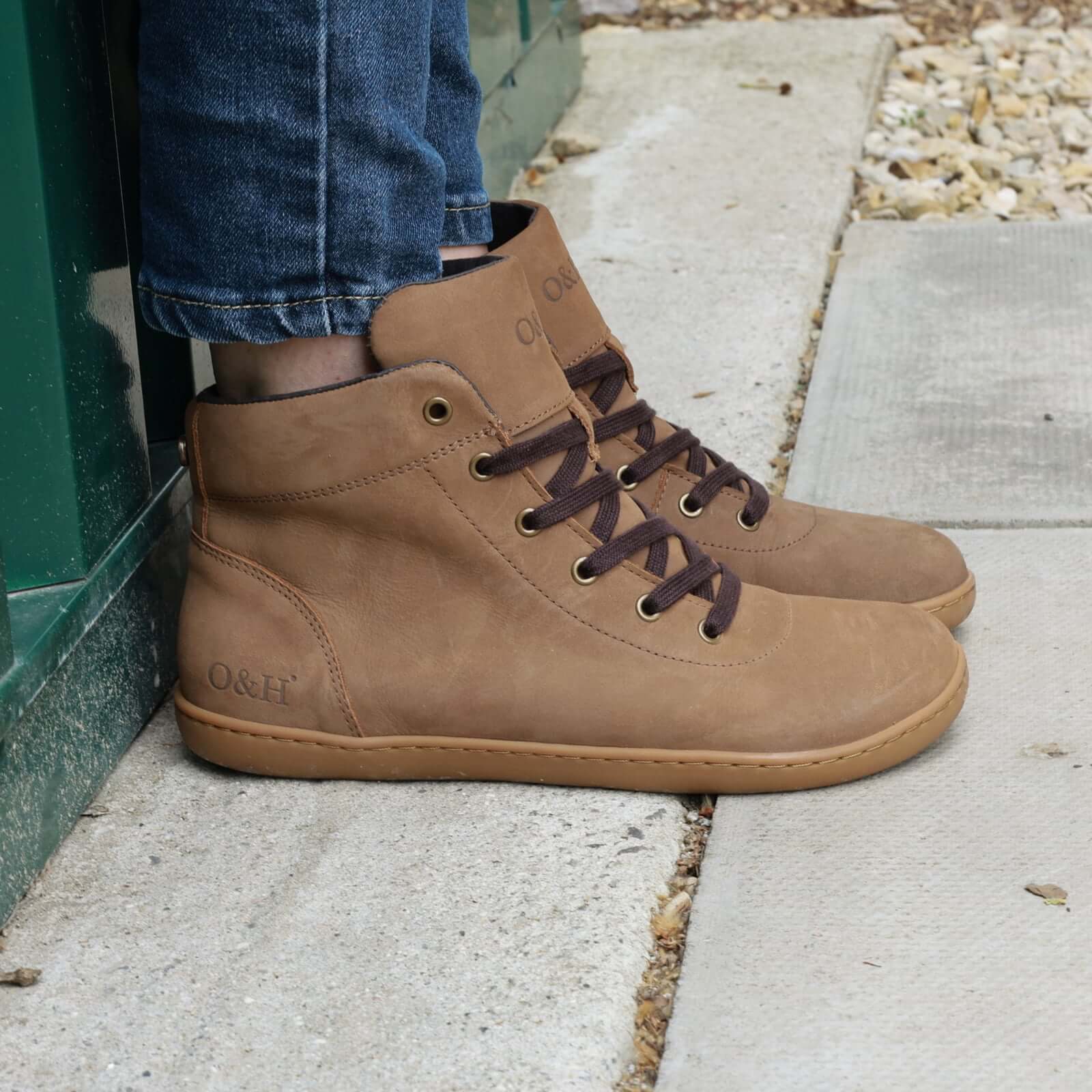 model standing outside in mulberry light brown barefoot ankle boots