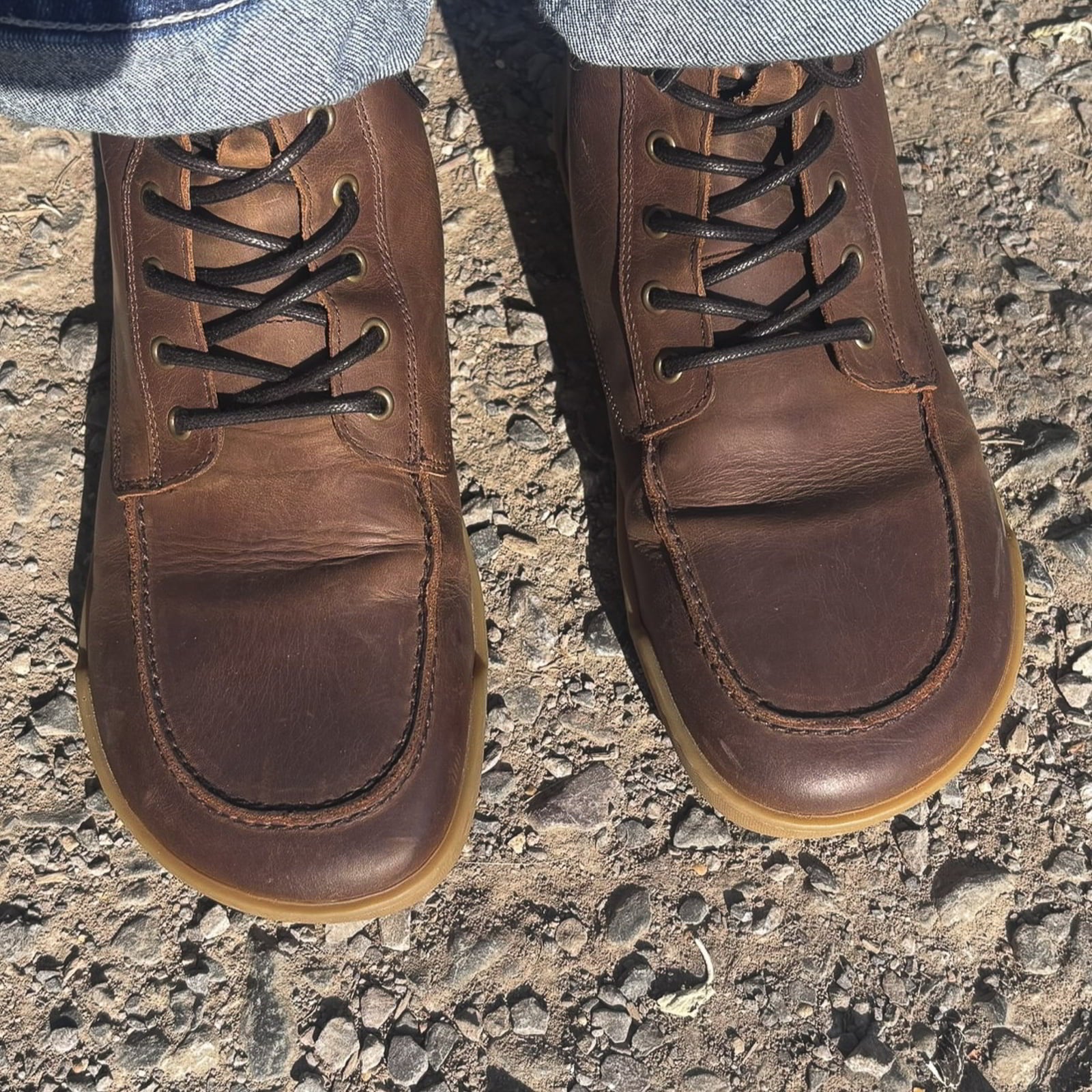 birds eye view of toe box shape of redwood dark brown barefoot boots on model outdoors