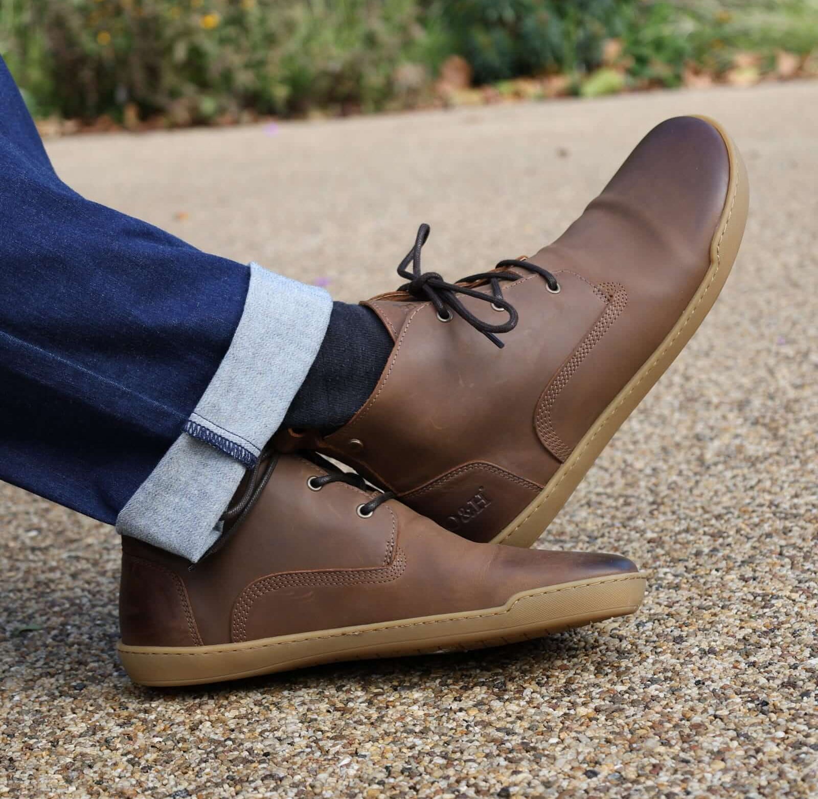 model sitting with spruce barefoot boots on with blue jeans