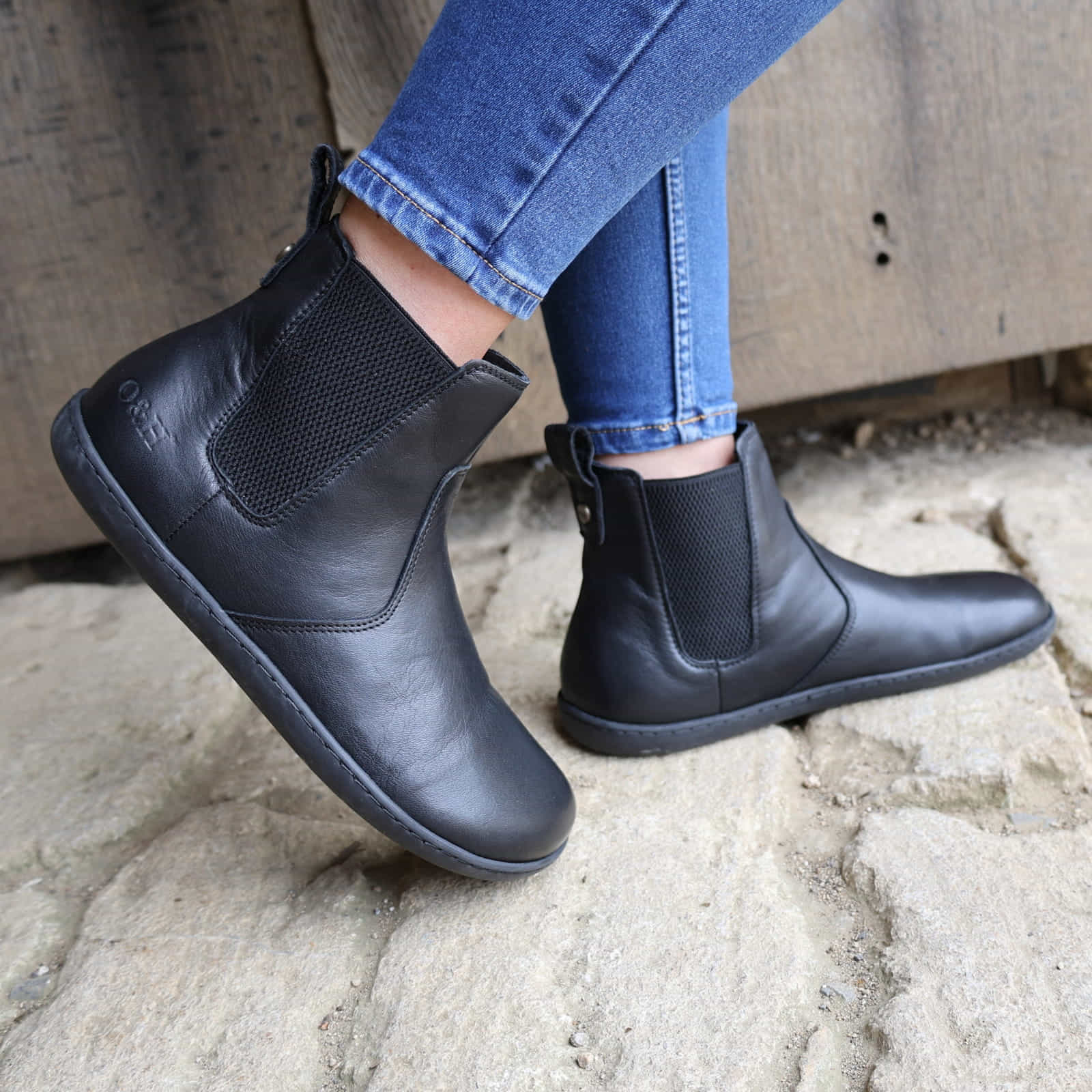 black barefoot chelsea boot shown on a model outdoors