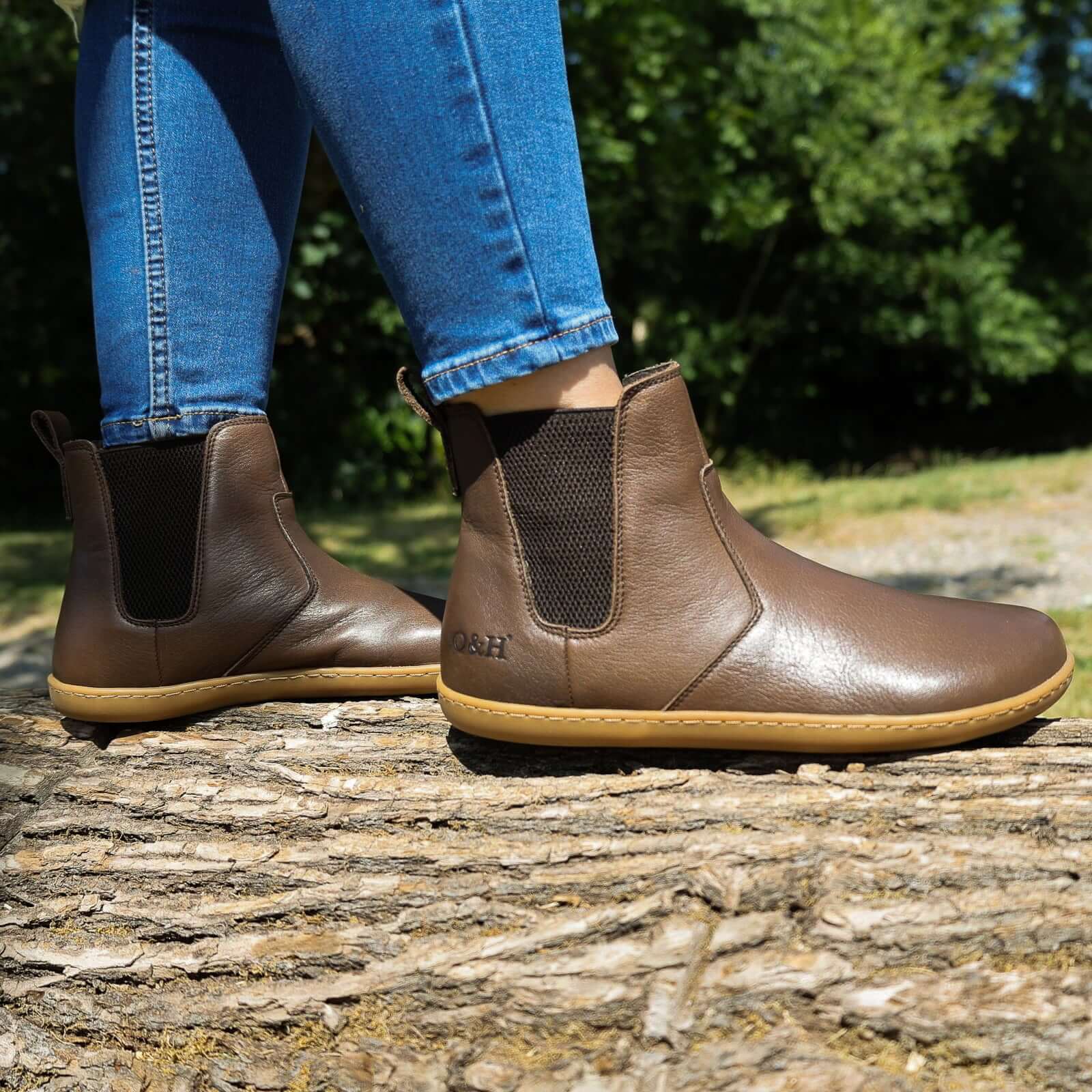 picture taken outdoors of model wearing brown chelsea boots