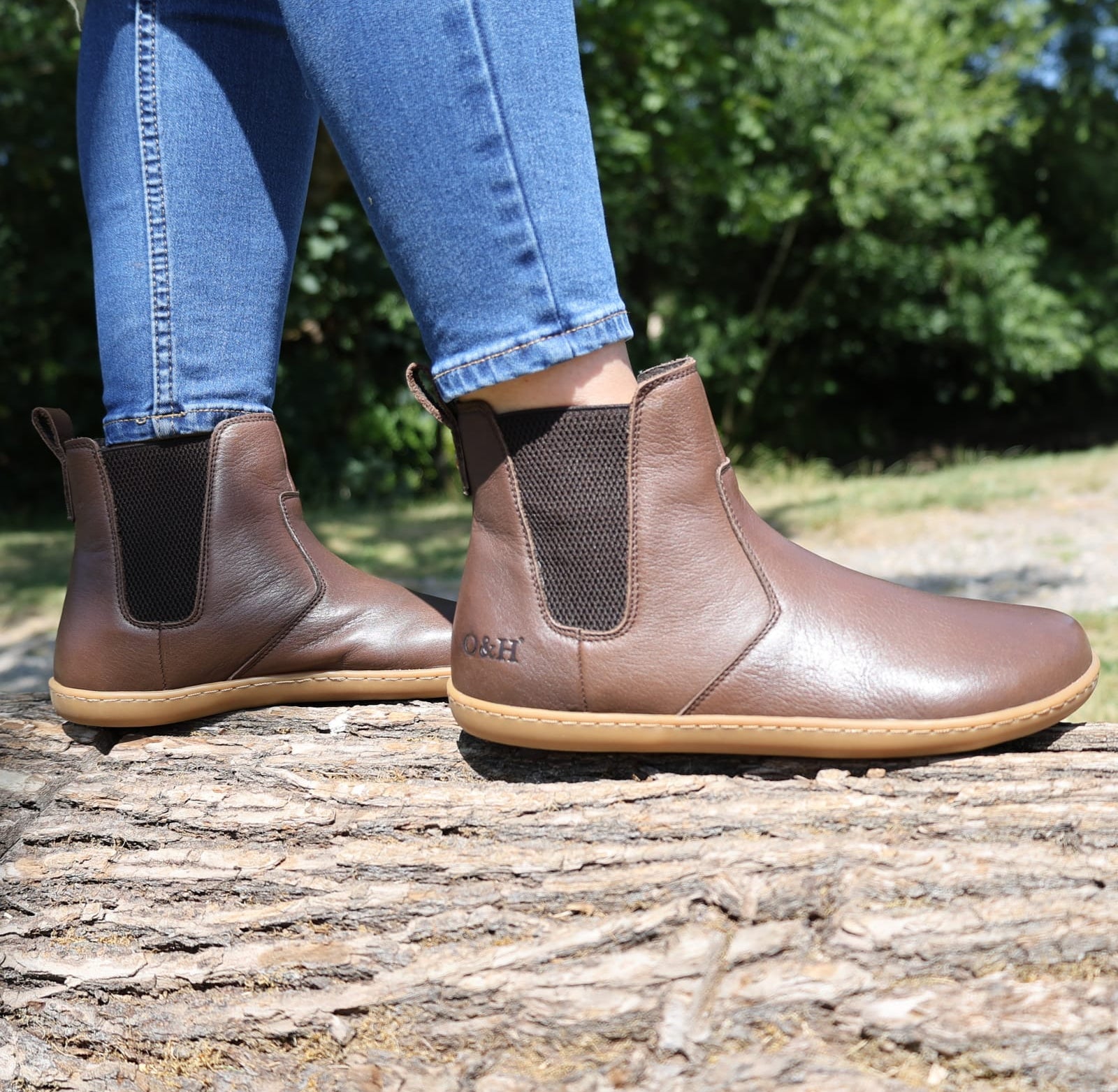 picture taken outdoors of model wearing brown chelsea boots