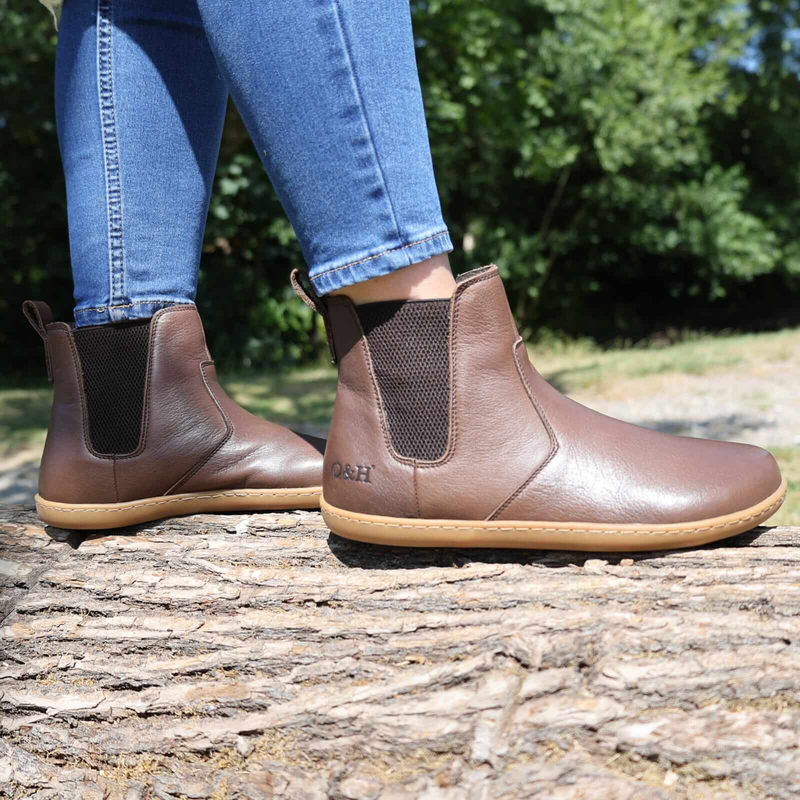 picture taken outdoors of model wearing brown chelsea boots