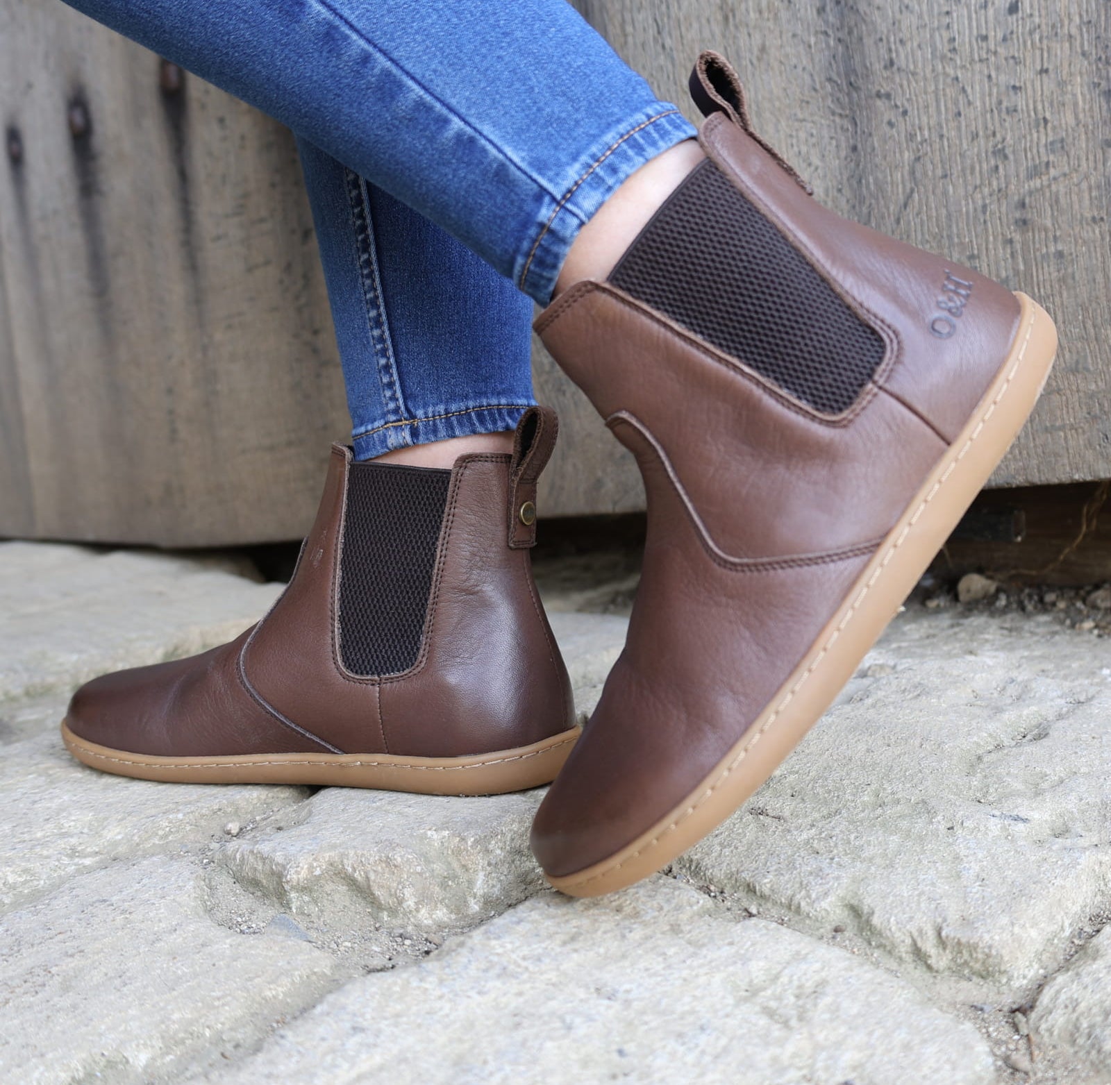 dark brown barefoot boot being worn by a model outside