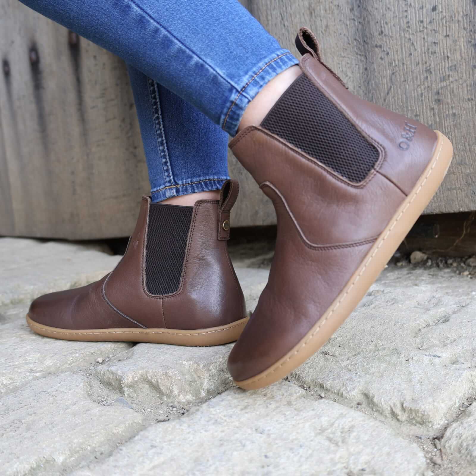 dark brown barefoot boot being worn by a model outside