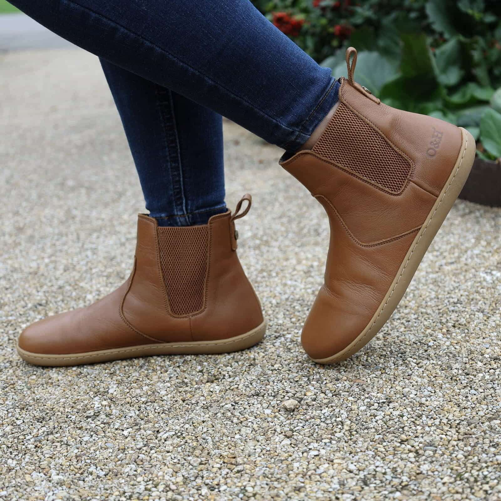 model wearing tan leather barefoot boots outdoors
