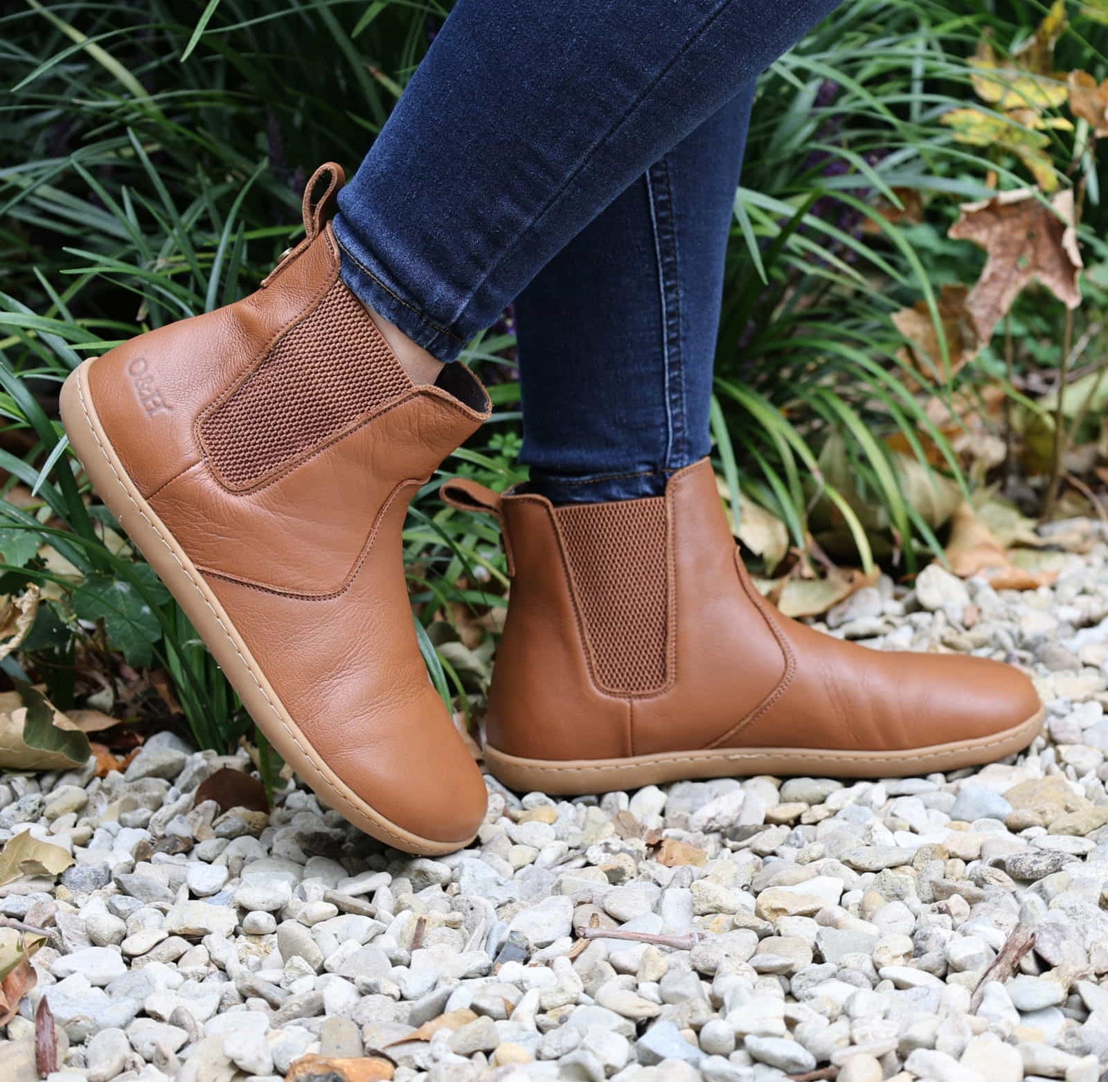 model wearing tan barefoot chelsea boots in an outdoor setting