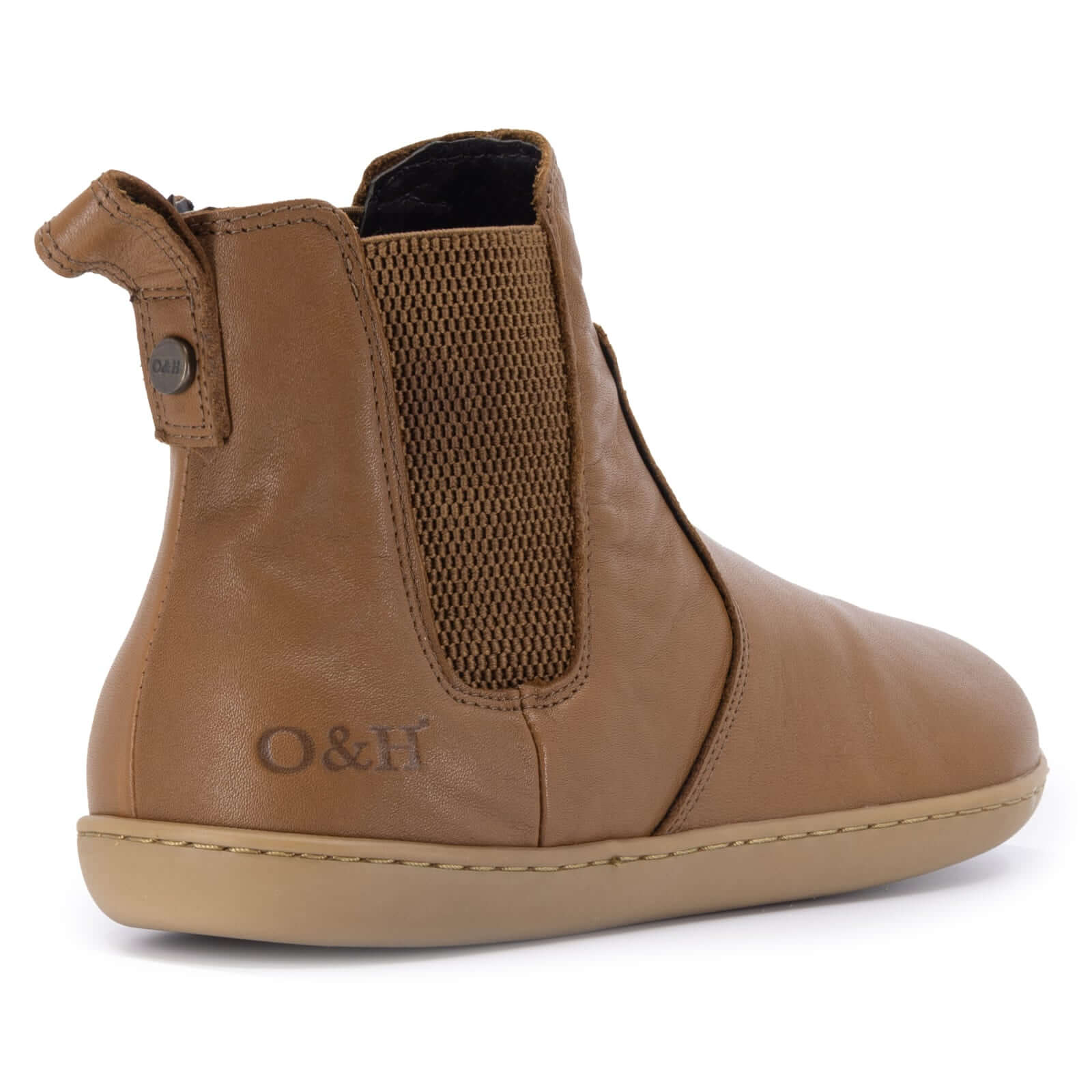 tan leather barefoot chelsea boots on a white background from the back of the boot
