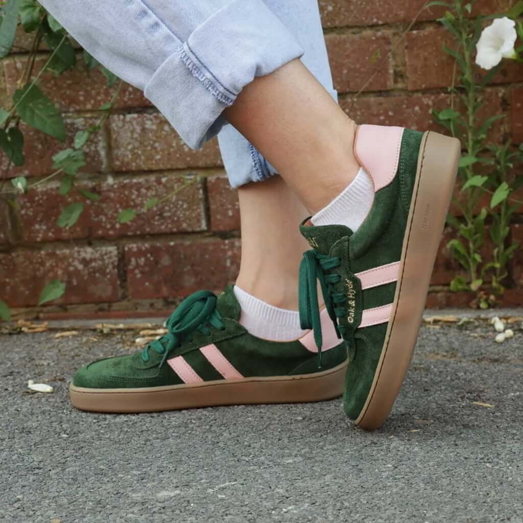 model standing outdoors wearing womens larch barefoot trainers in green pink with blue jeans