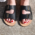 model wearing black acacia womens leather barefoot sandals showing the foot shaped toe box