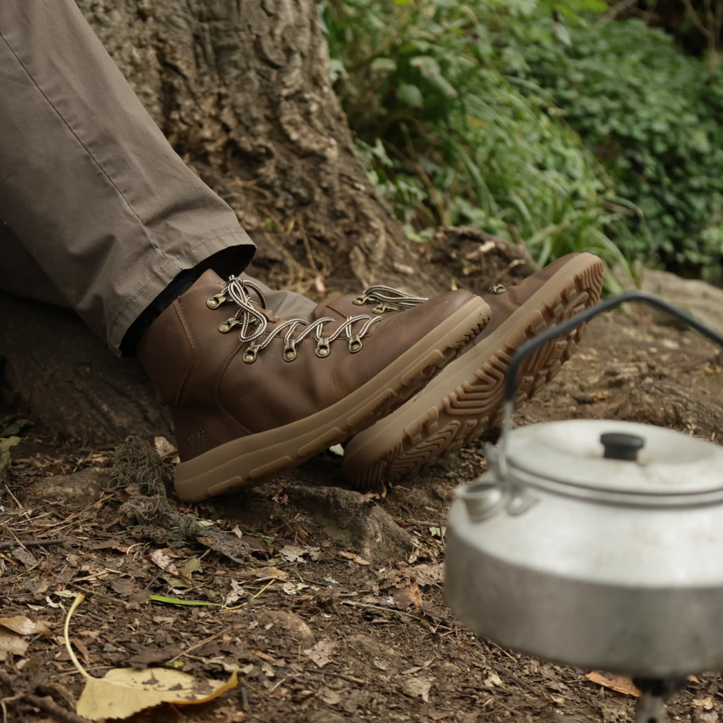model sitting in woodland setting wearing mens blackthorn barefoot walking boots in brown