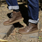 model walking up wooden steps wearing mens blackthorn barefoot walking boots with jeans