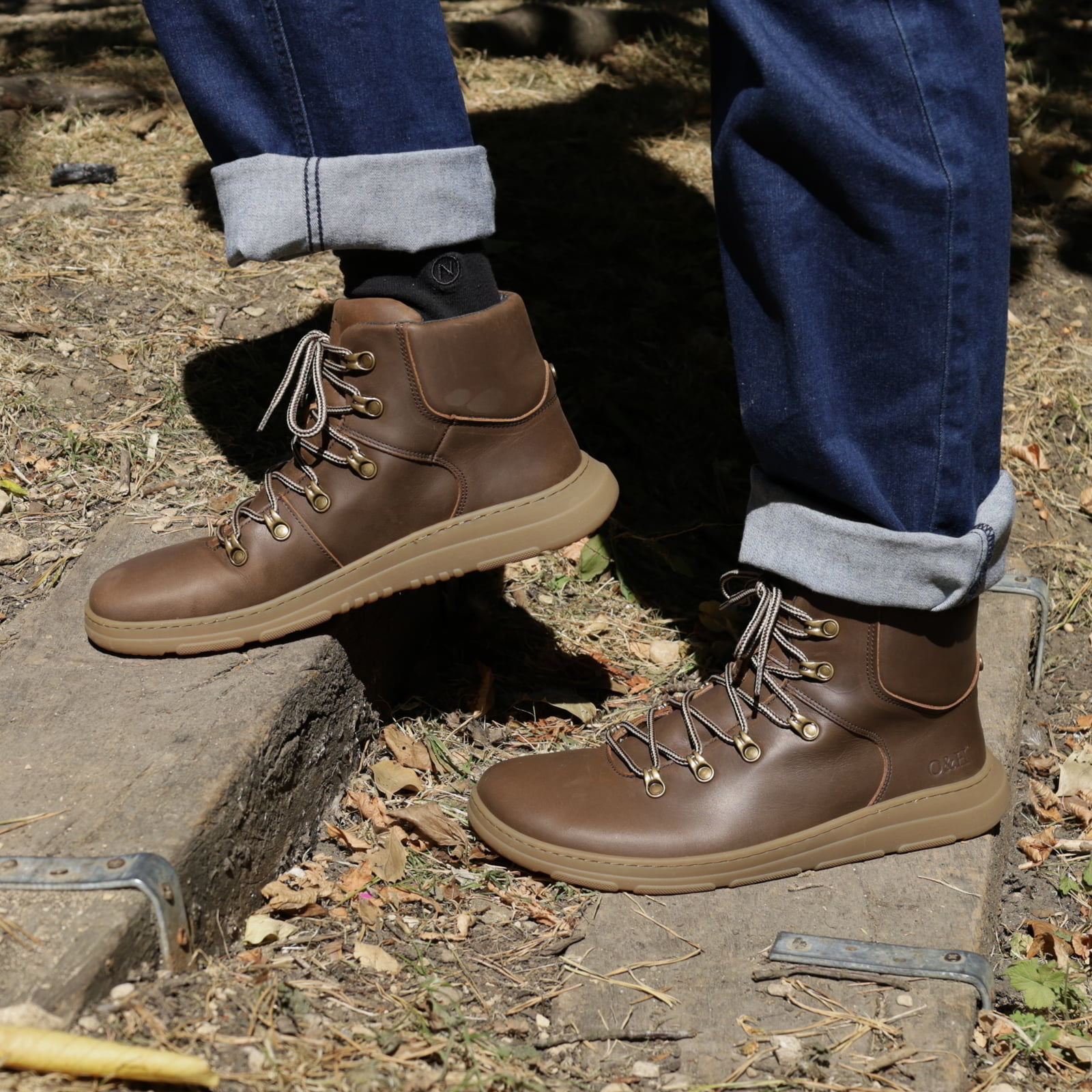 model walking up wooden steps wearing mens blackthorn barefoot walking boots with jeans