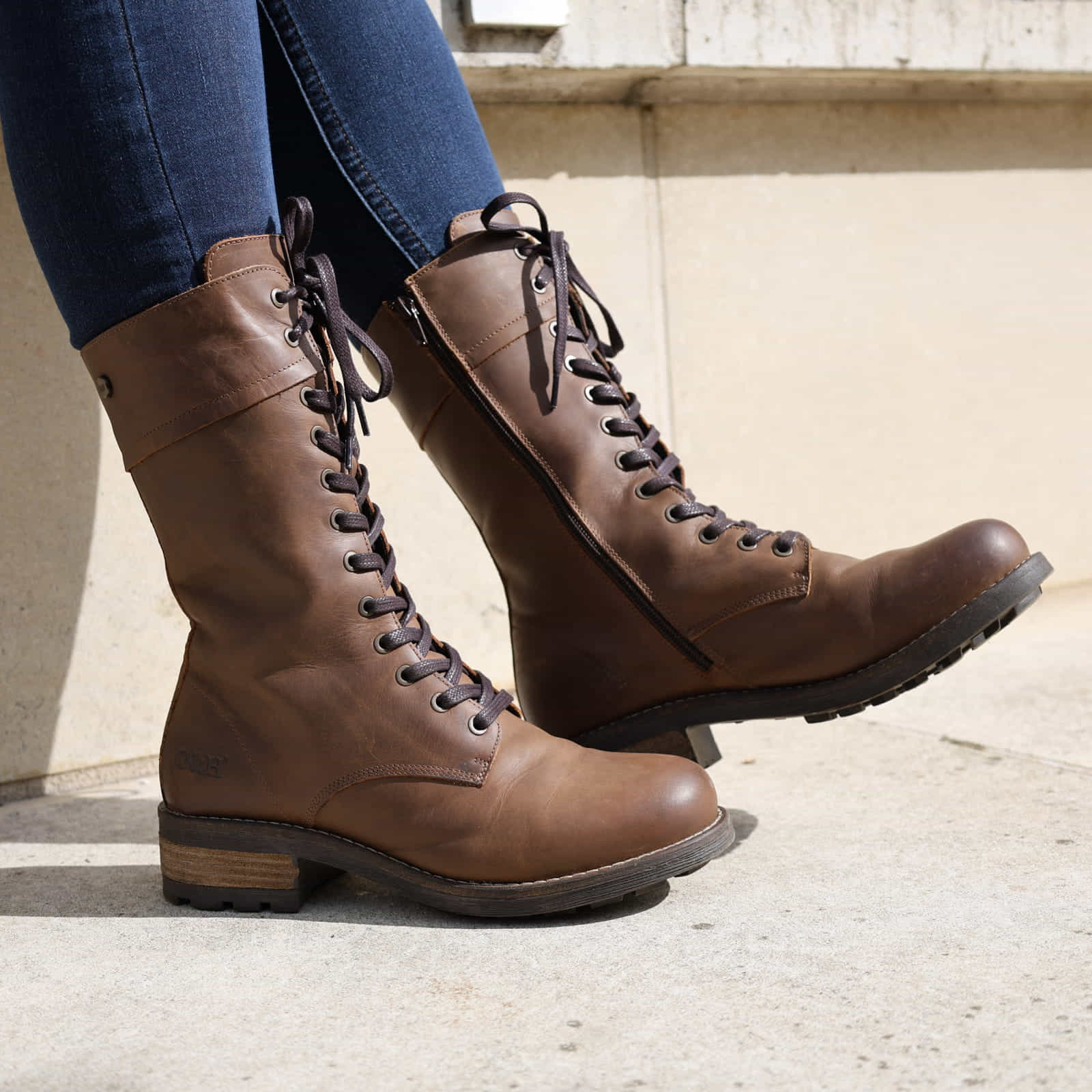 Dark brown Bridge 12 military boots worn with jeans, front angled view outdoors