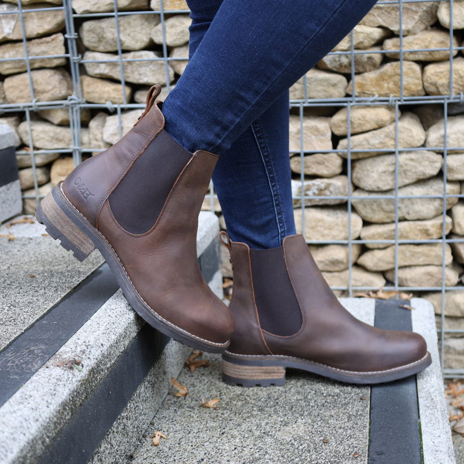 Dark brown Bridge Chelsea 2 boots worn with jeans outdoors on a paved surface
