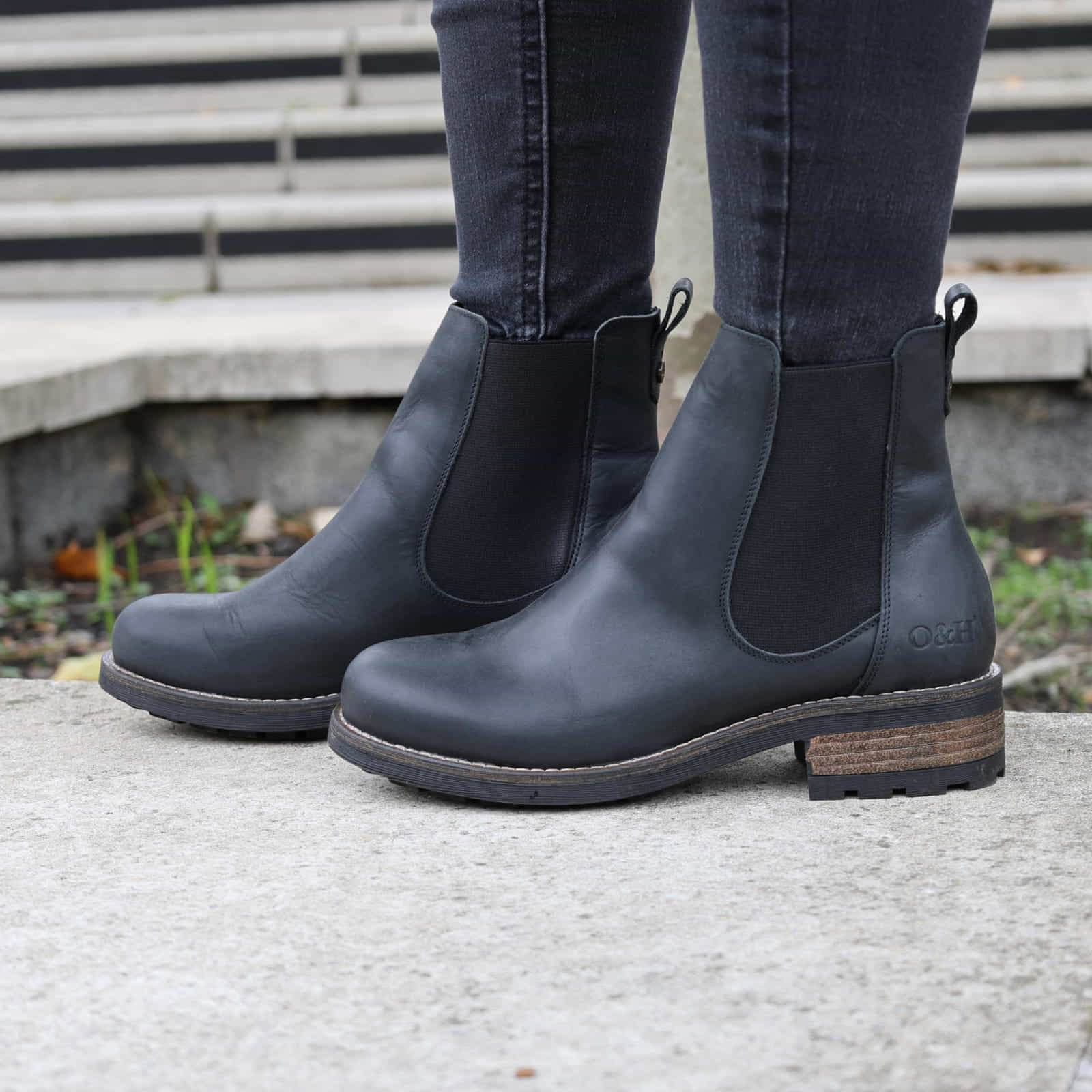Black Bridge Chelsea 2 boots worn with jeans standing outdoors on a paved surface