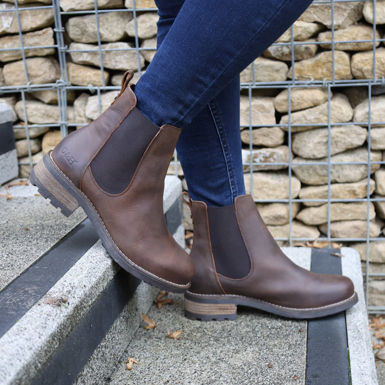 Dark brown Bridge Chelsea 2 boots worn with jeans outdoors on a paved surface