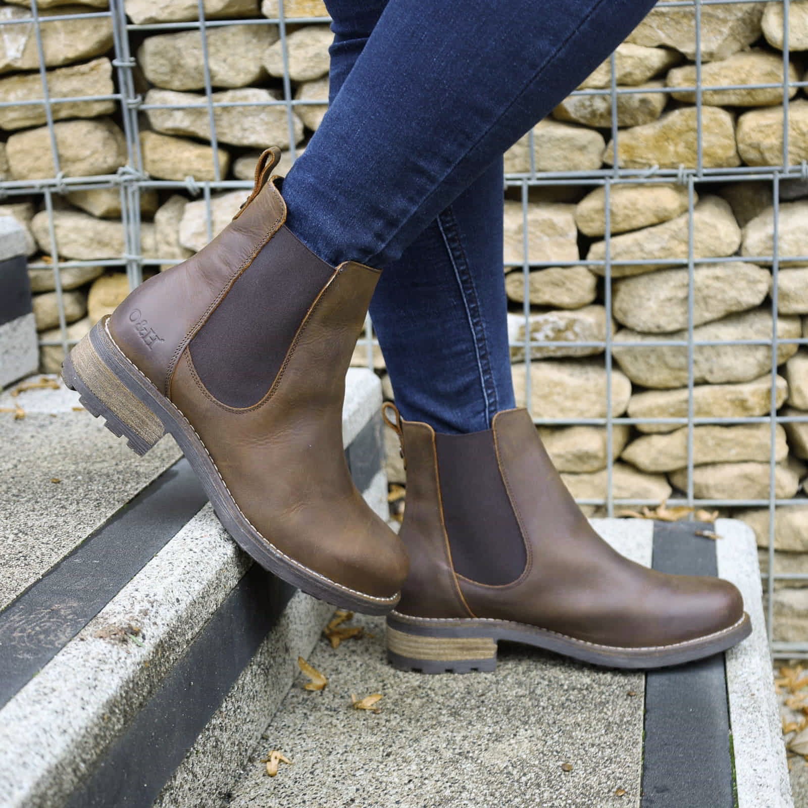 Dark brown Bridge Chelsea 2 boots worn with jeans outdoors on a paved surface