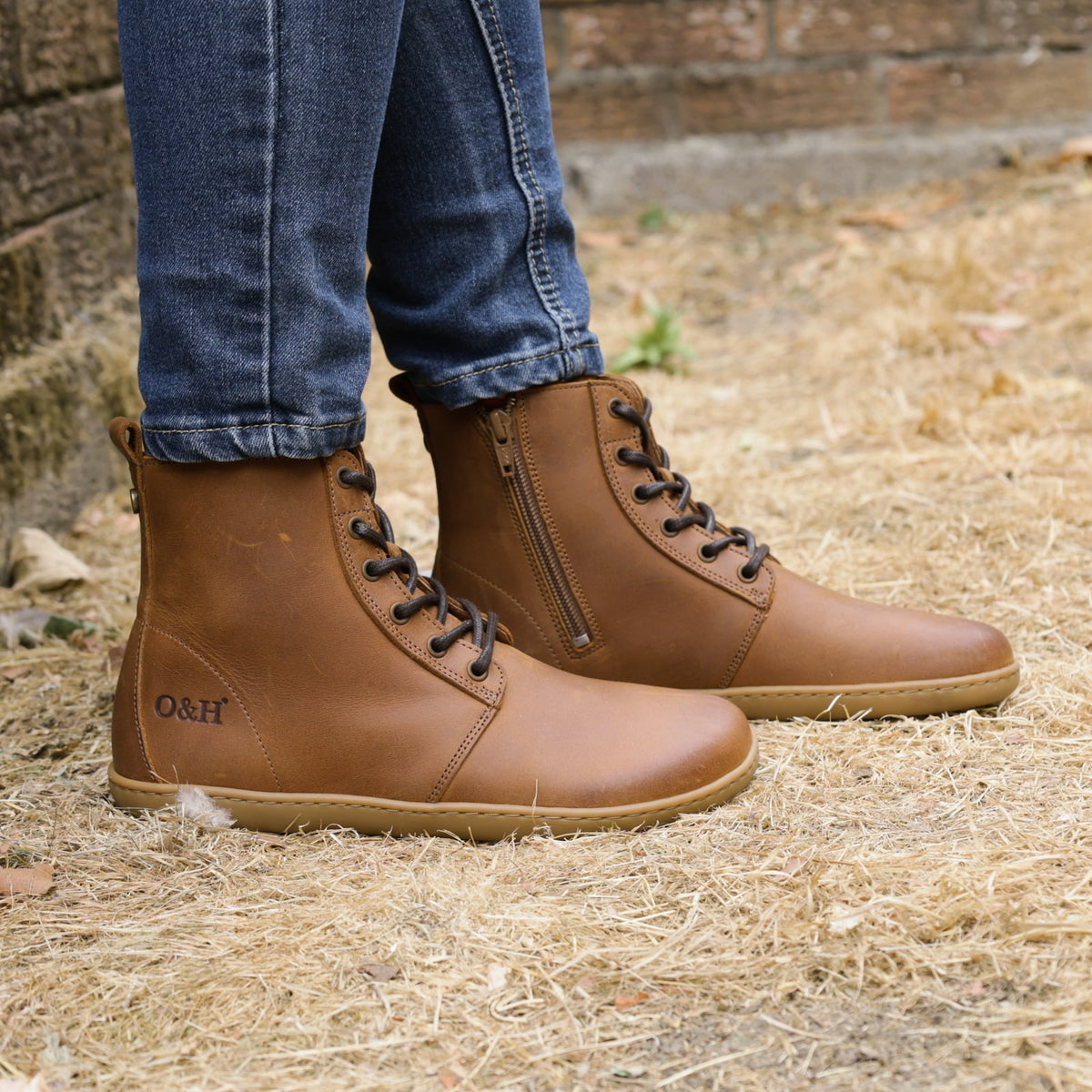 model wearing womens cherry cognac barefoot boots on grass floor