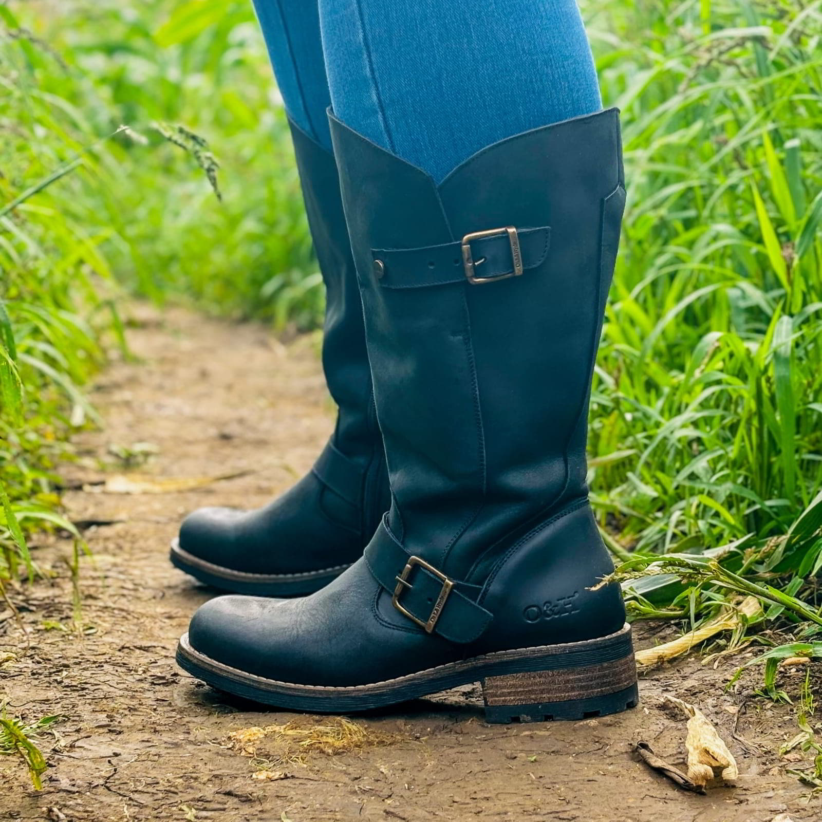 Black Crest 2 wide calf tall boots worn outdoors while walking on grass