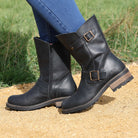 Black Crest Demi 2 ankle boots worn outdoors stepping on sandy ground