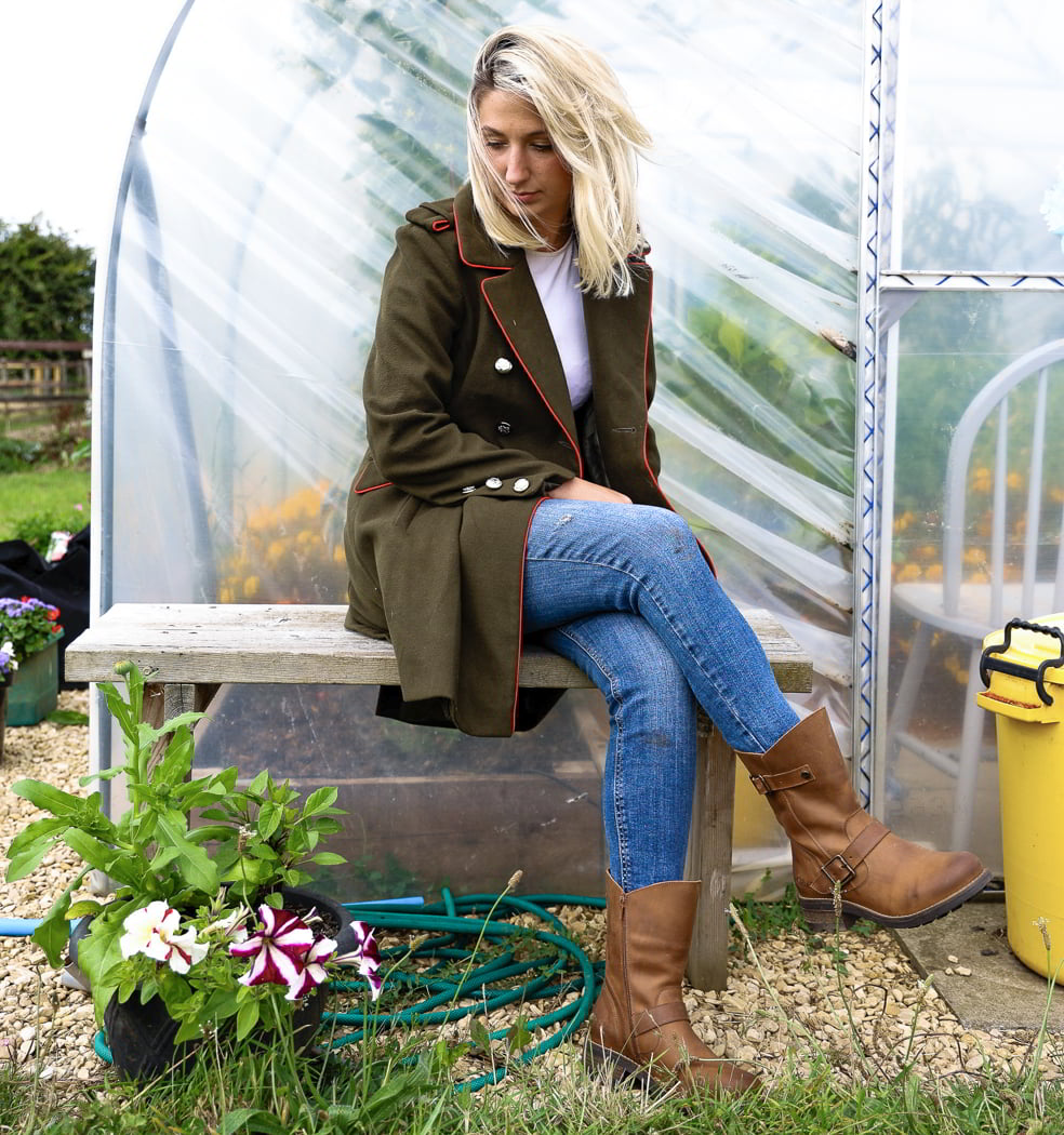model sitting n bench outdoors wearing crest demi 2 leather boots in tan cognac
