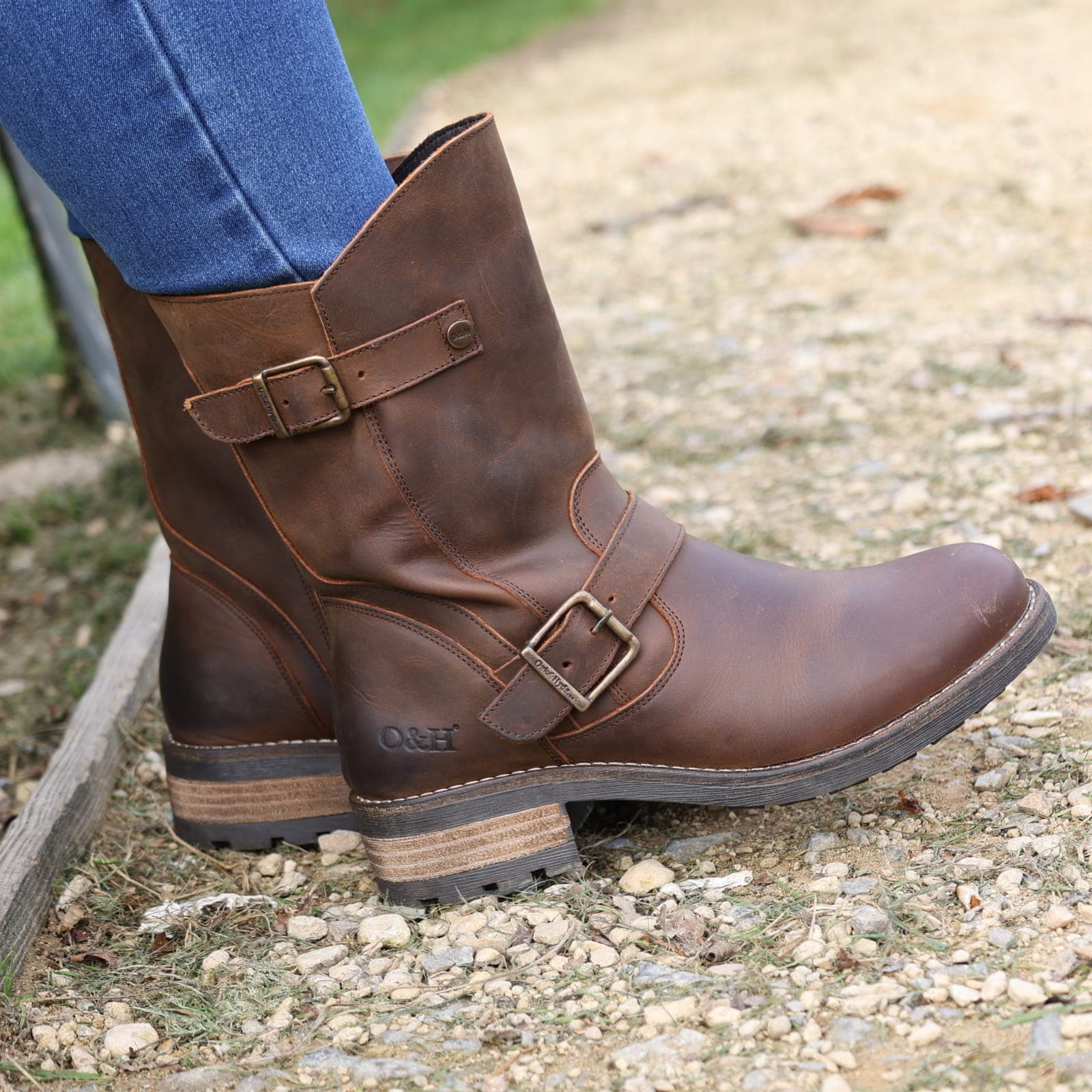 Dark brown Crest Demi 2 ankle boots worn outdoors stepping on gravel